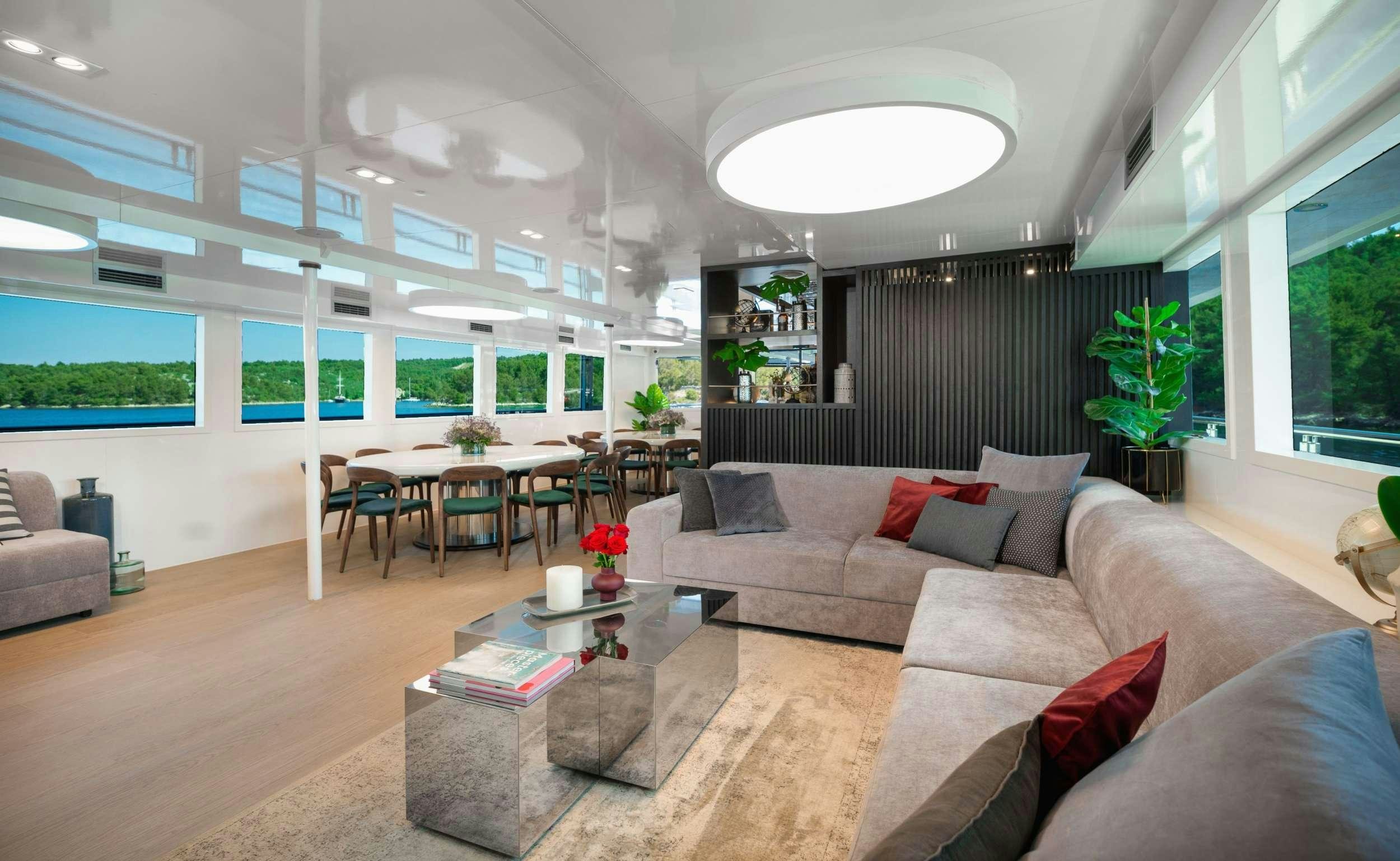 a living room with a couch and a table aboard AGAPE ROSE Yacht for Charter