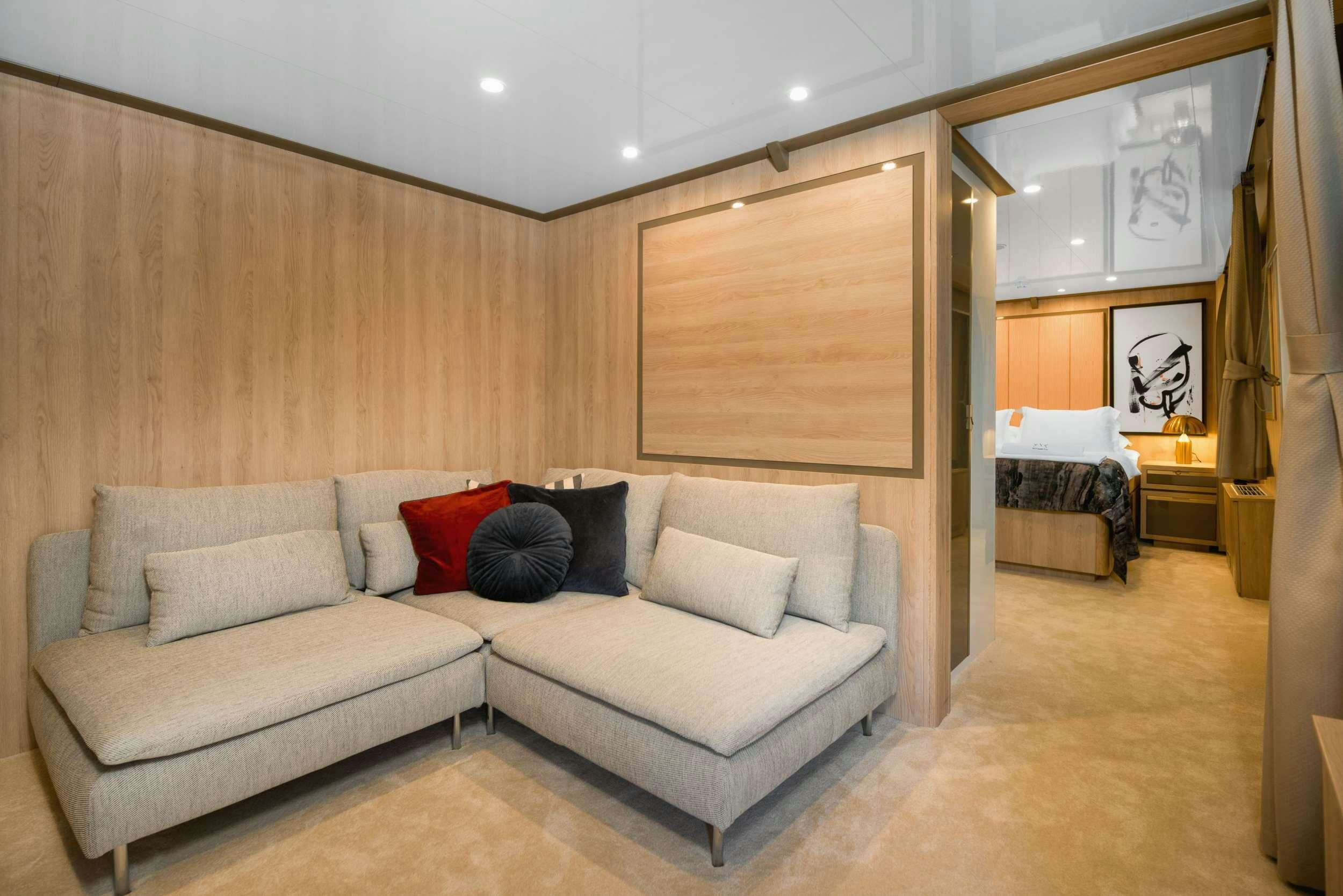 a living room with a couch and a mirror aboard AGAPE ROSE Yacht for Charter
