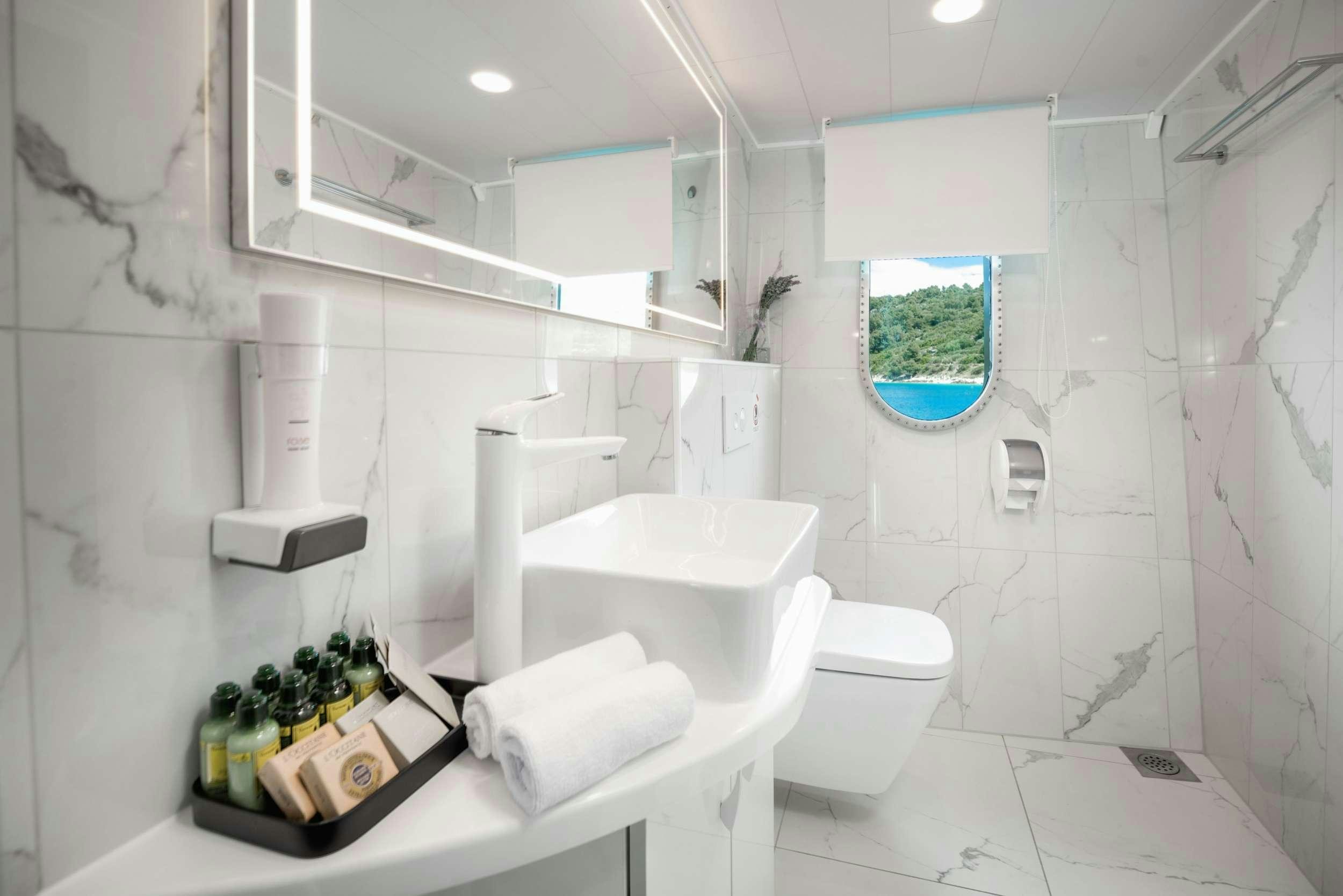 a bathroom with a tub sink and toilet aboard AGAPE ROSE Yacht for Charter