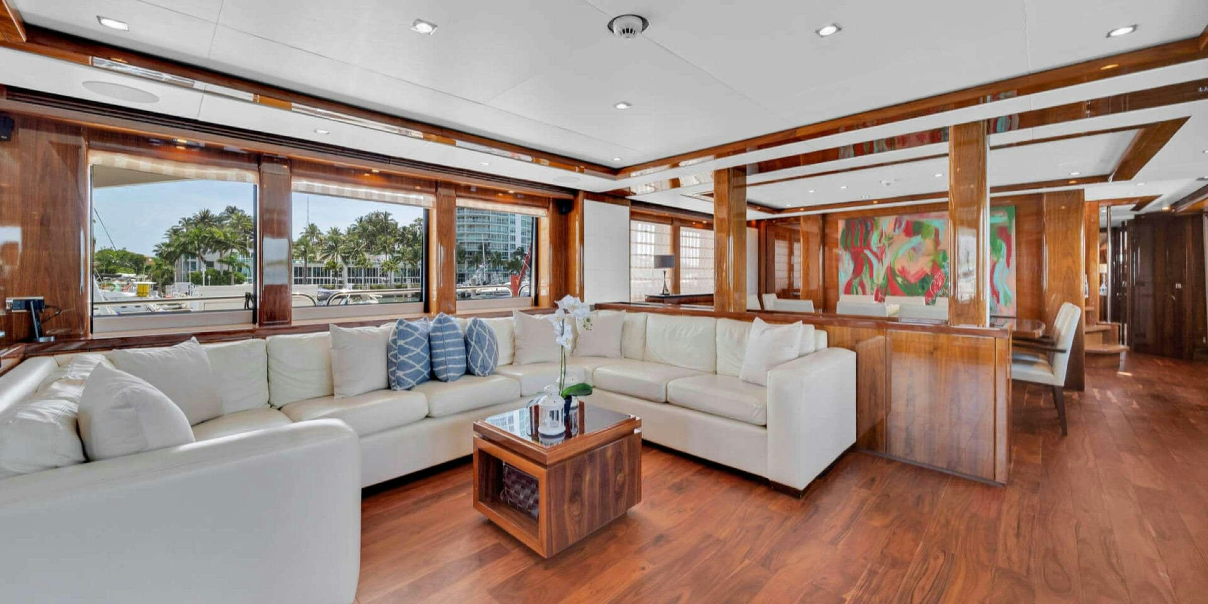 a living room with a couch and a table aboard viva la vida Yacht for Charter