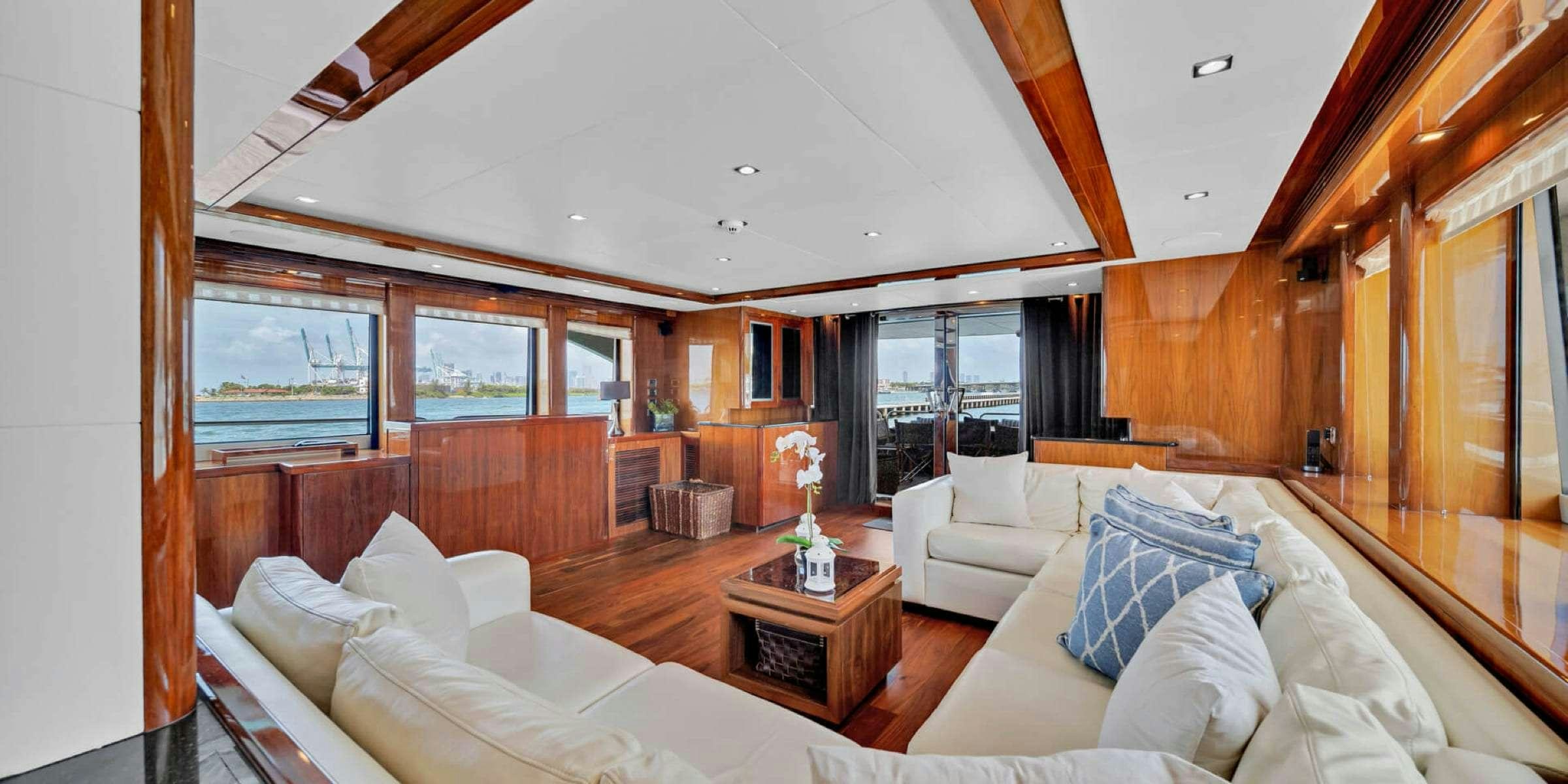 a large room with a couch and a table aboard viva la vida Yacht for Charter