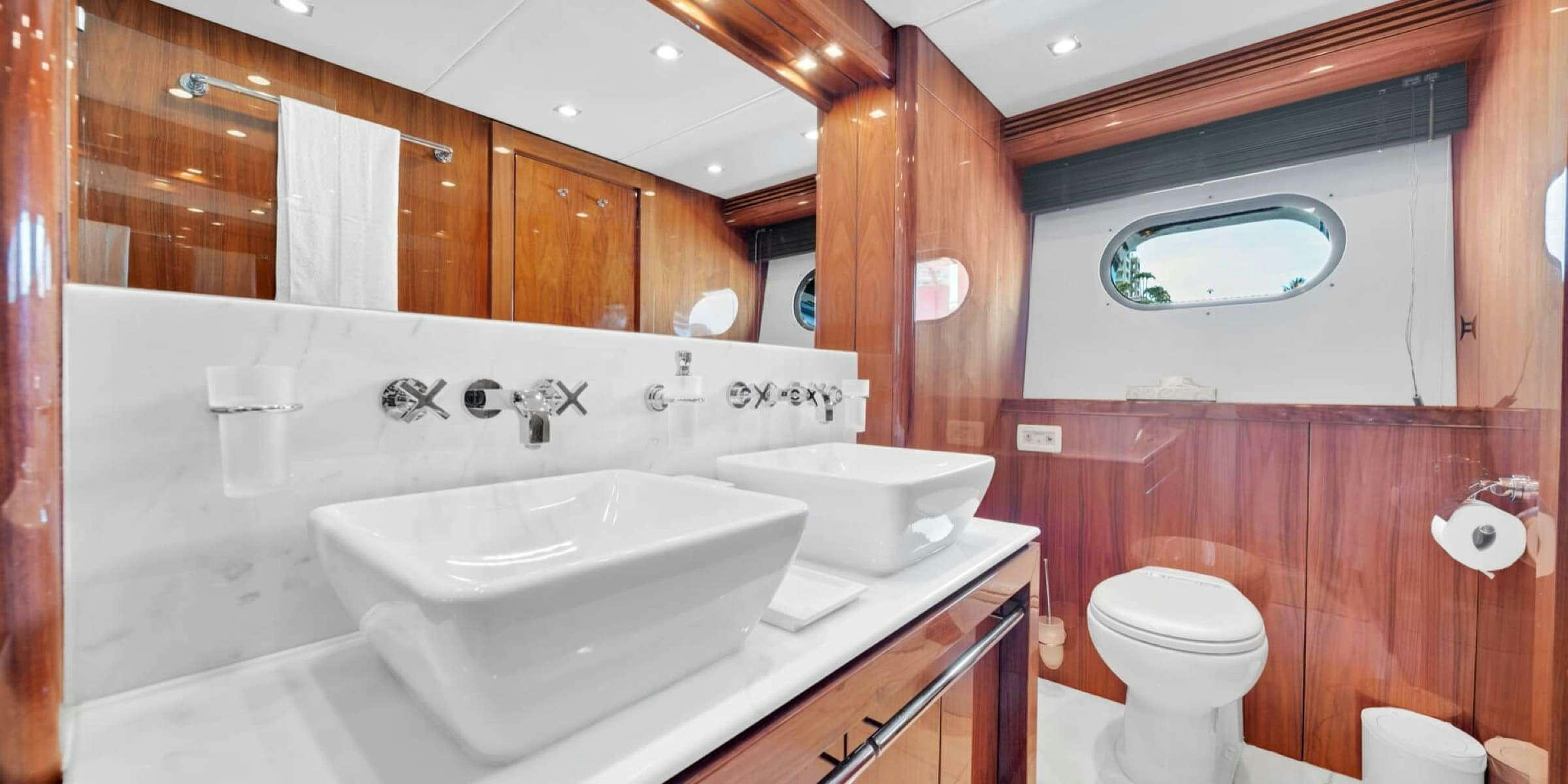 a bathroom with a sink toilet and bathtub aboard viva la vida Yacht for Charter