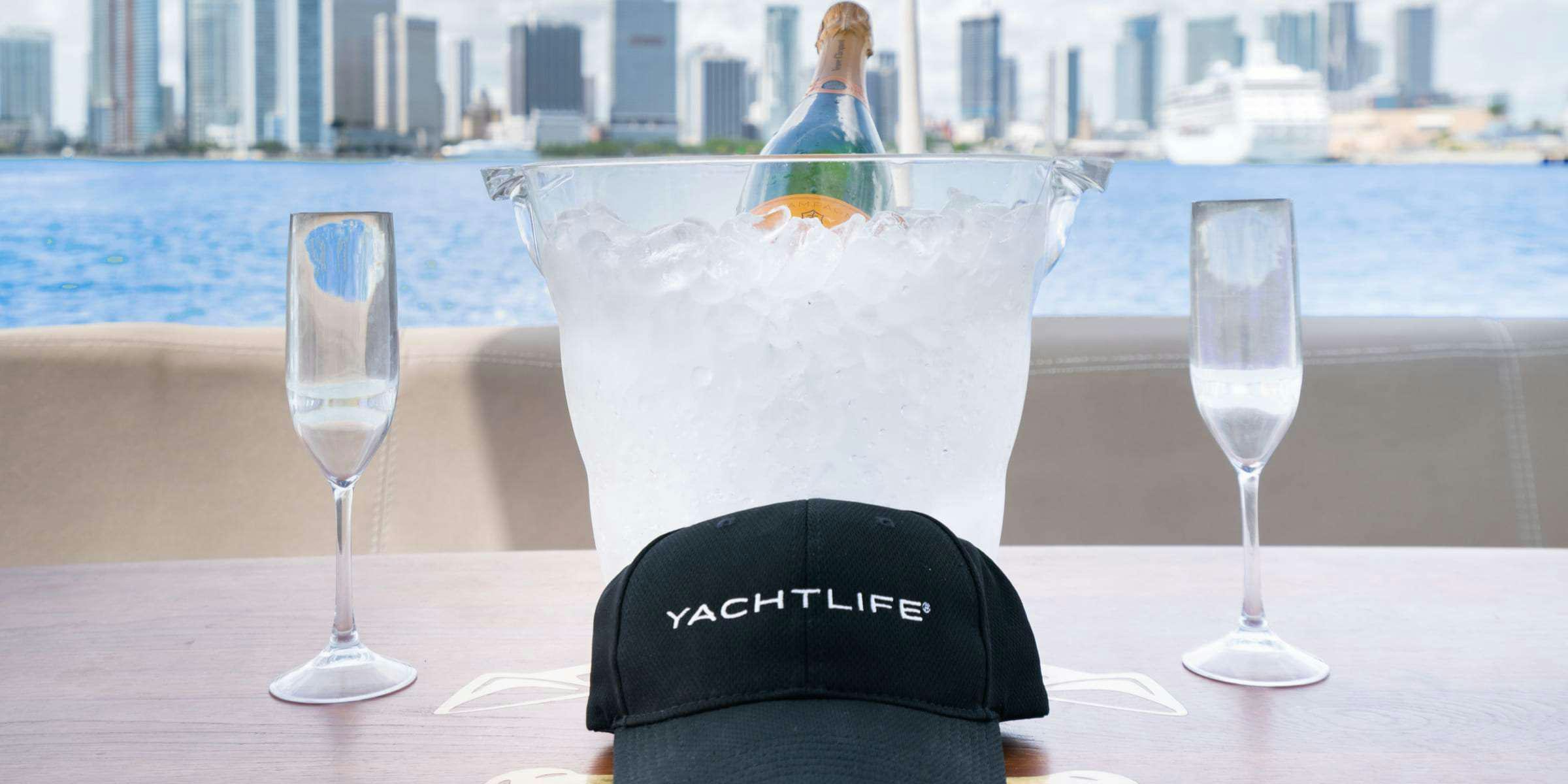 a hat and glasses on a table aboard Legacy Yacht for Charter