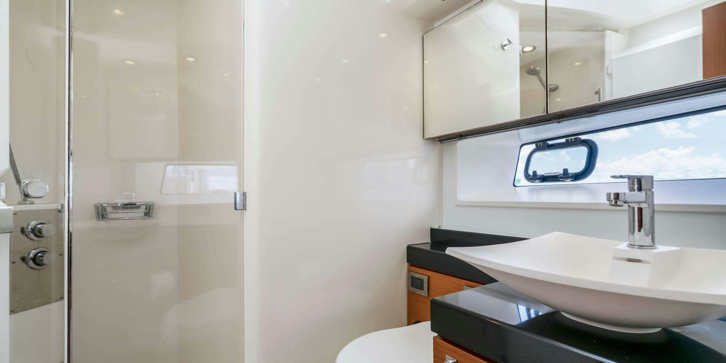 a bathroom with a sink and a mirror aboard Legacy Yacht for Charter