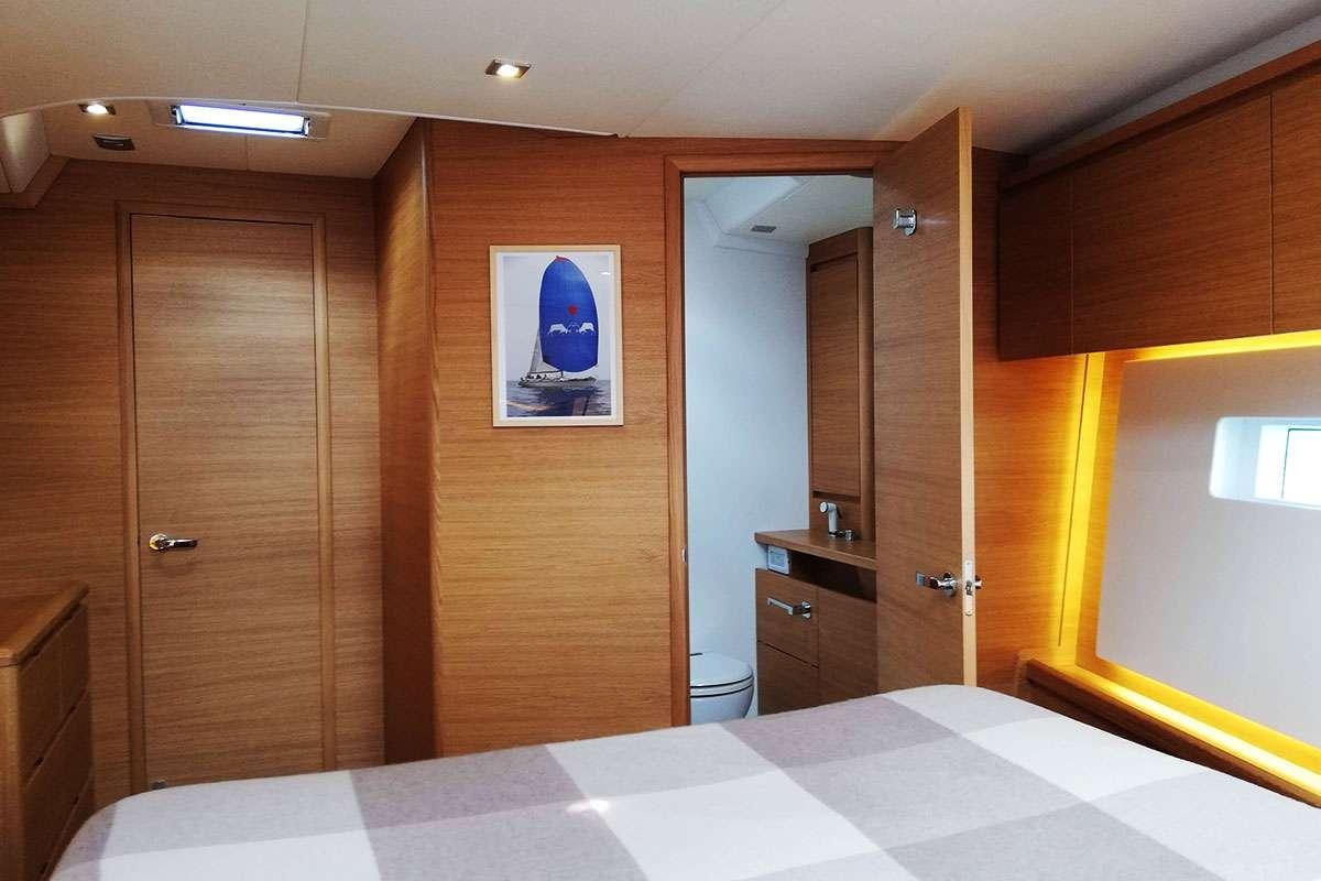 a large bathroom with wooden cabinets aboard Futura Yacht for Charter