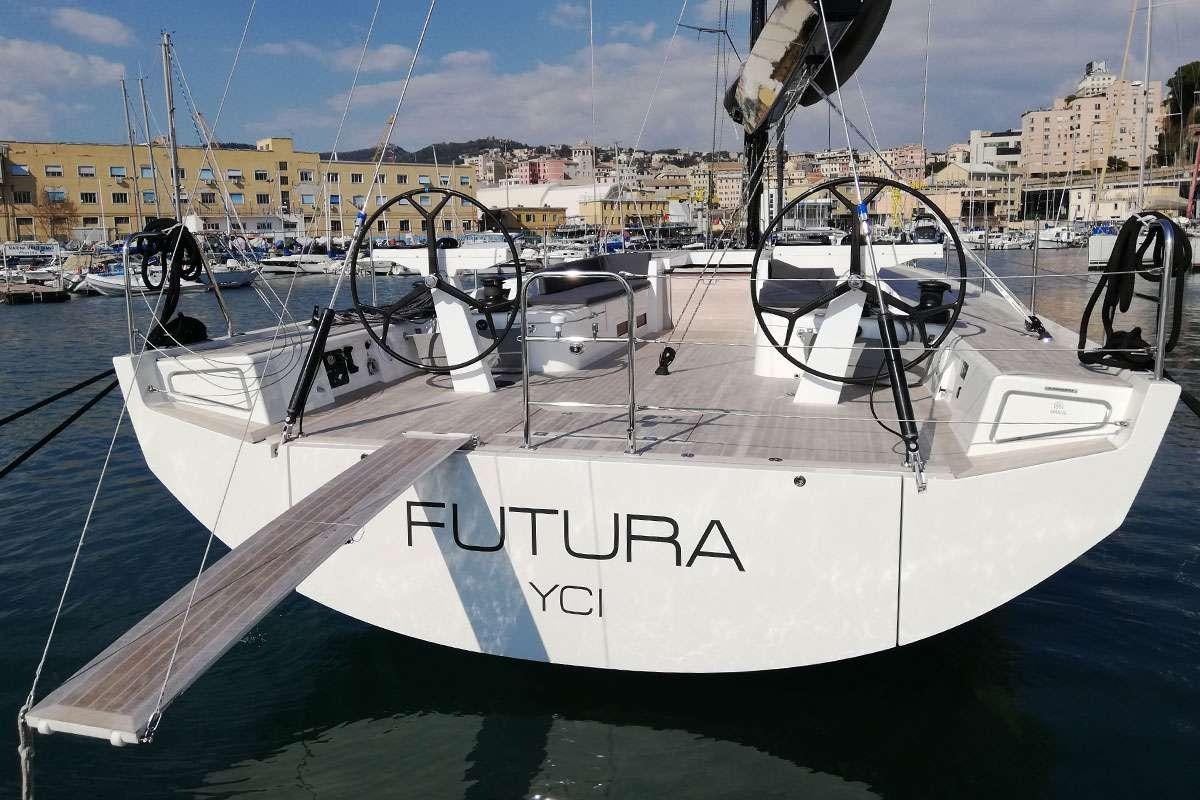 a white boat in a harbor aboard Futura Yacht for Charter