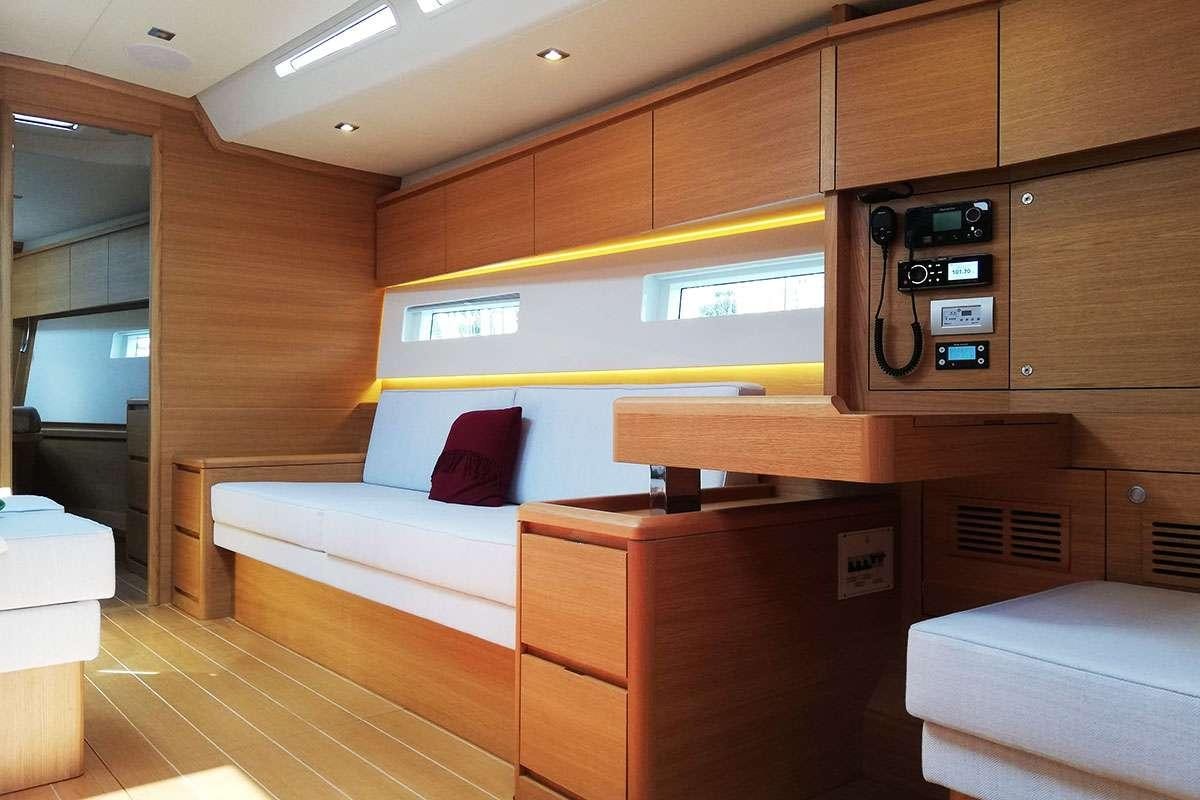 a room with a couch and a bed aboard Futura Yacht for Charter