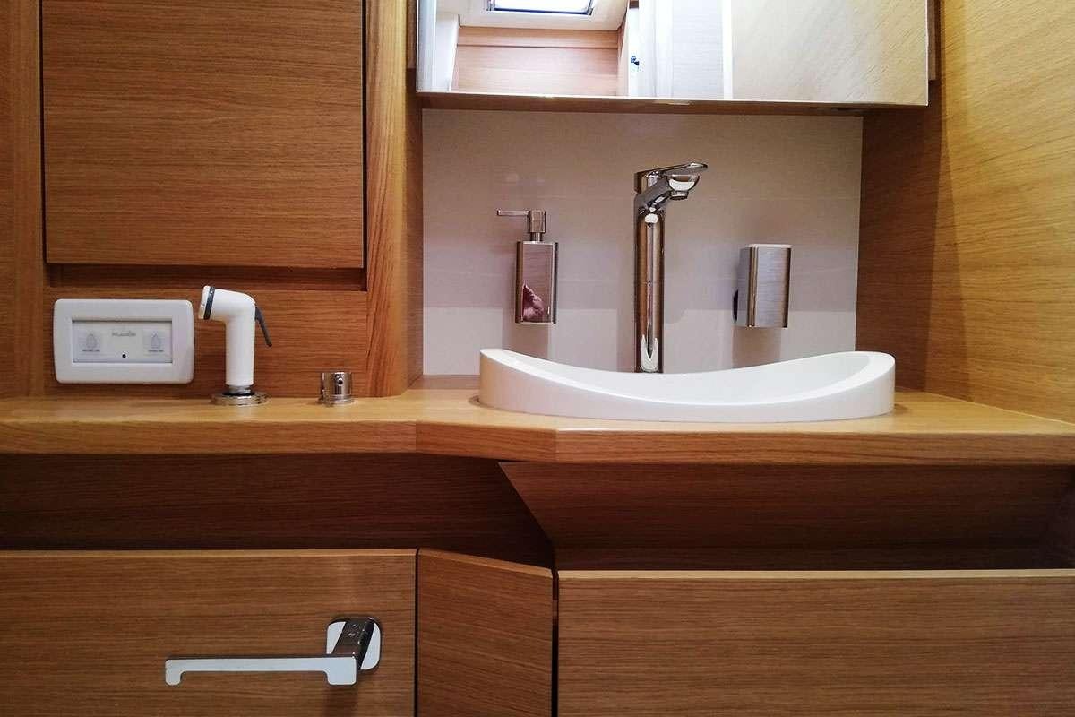 a bathroom with a sink and a faucet aboard Futura Yacht for Charter