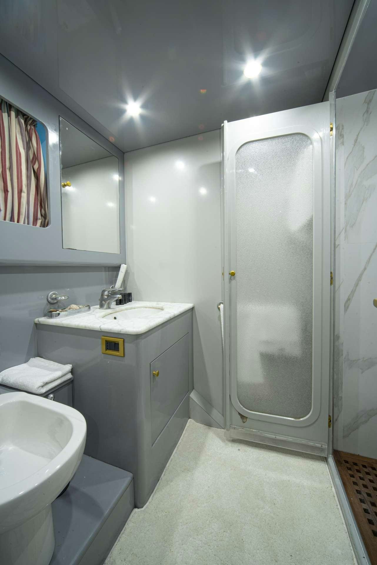 a bathroom with a sink and a shower aboard WISH Yacht for Charter