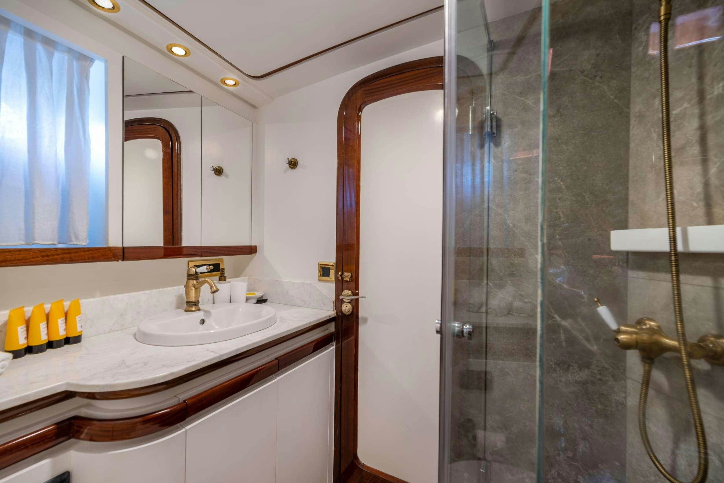 a bathroom with a glass shower aboard SPIRIT L Yacht for Charter