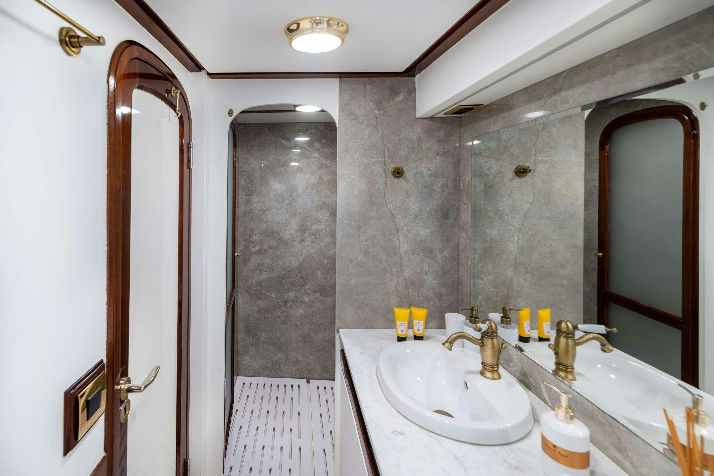 a bathroom with a sink and a mirror aboard SPIRIT L Yacht for Charter
