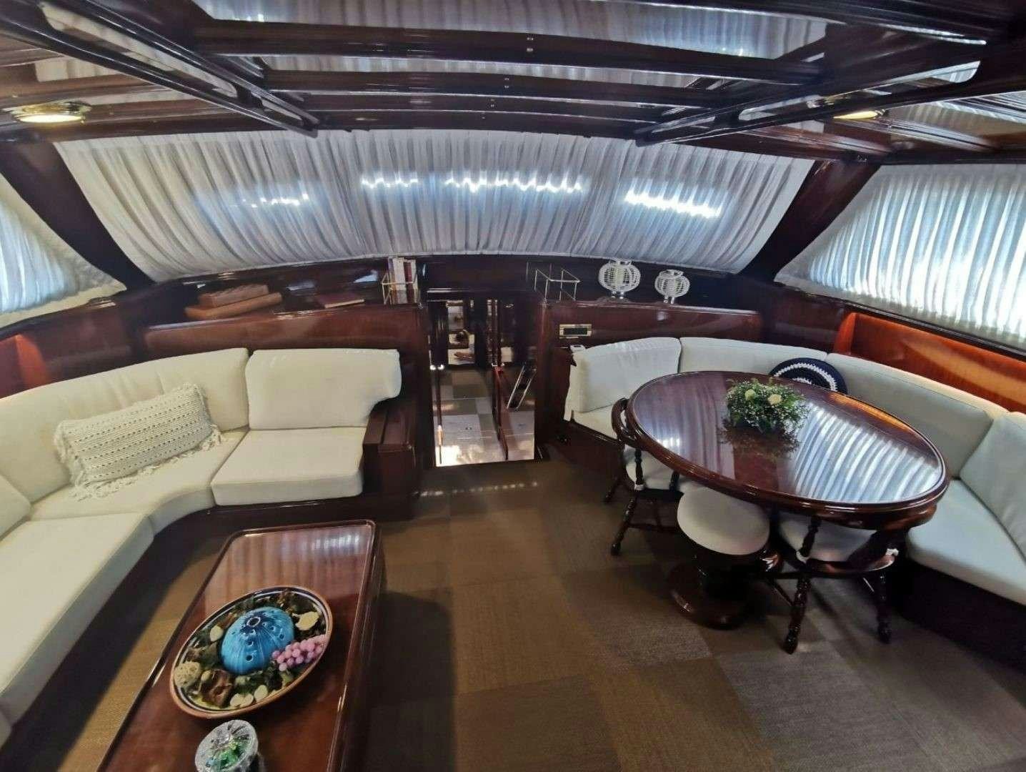 a room with a table and chairs aboard SPIRIT L Yacht for Charter