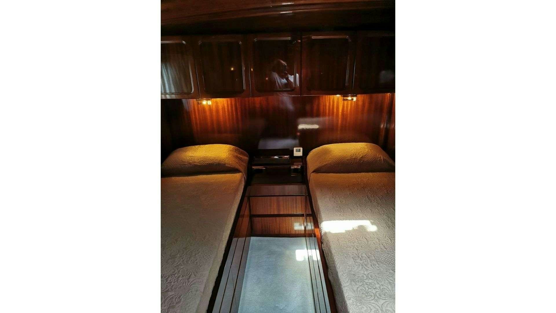 a room with a bed and a couch aboard SPIRIT L Yacht for Charter