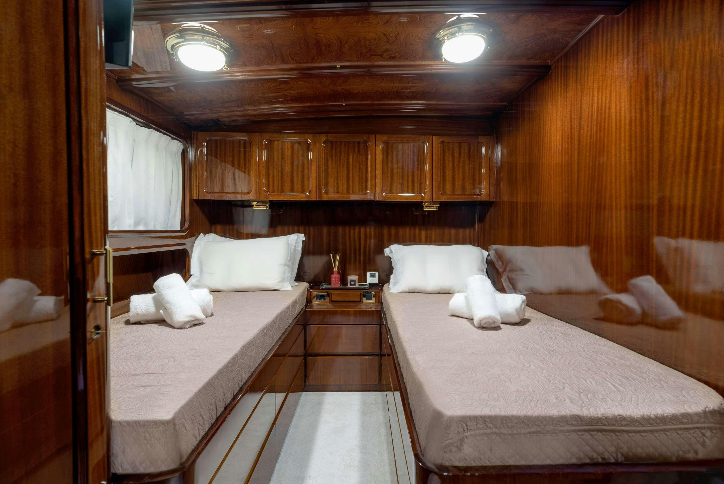 a room with a bed and a couch aboard SPIRIT L Yacht for Charter