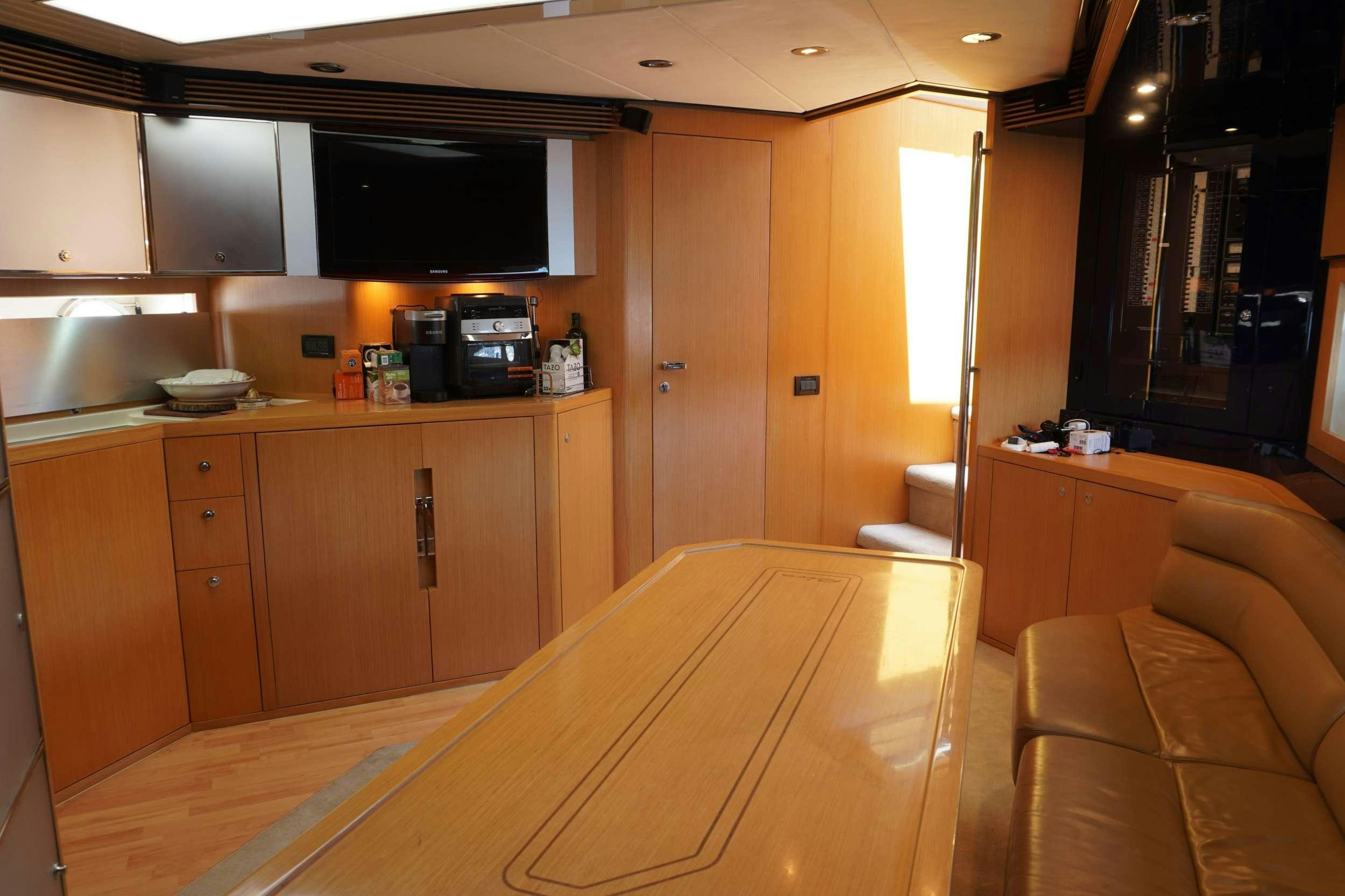 a room with a couch and a television aboard EXPRESSO Yacht for Charter