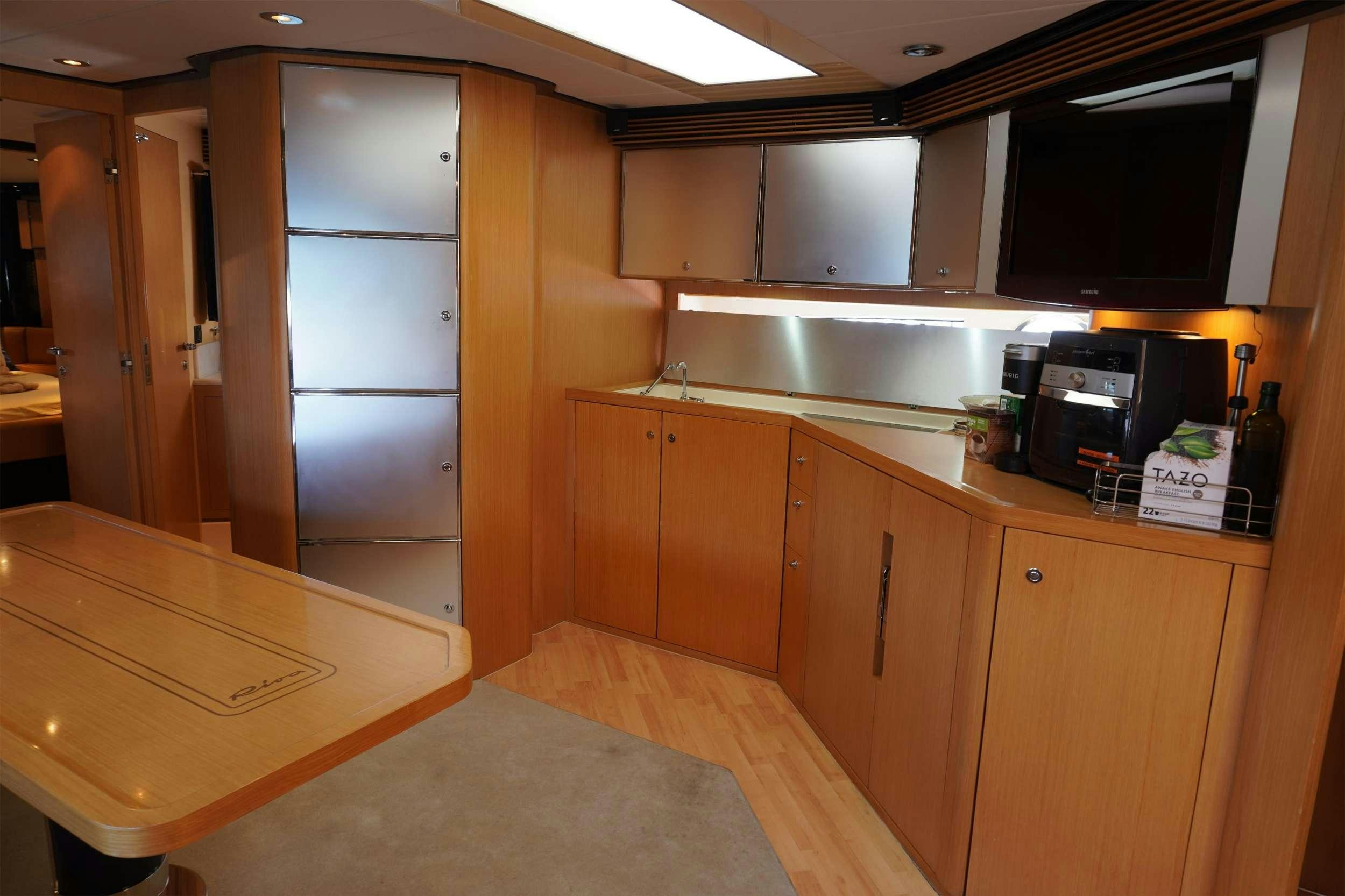 a room with wooden cabinets and a microwave oven aboard EXPRESSO Yacht for Charter