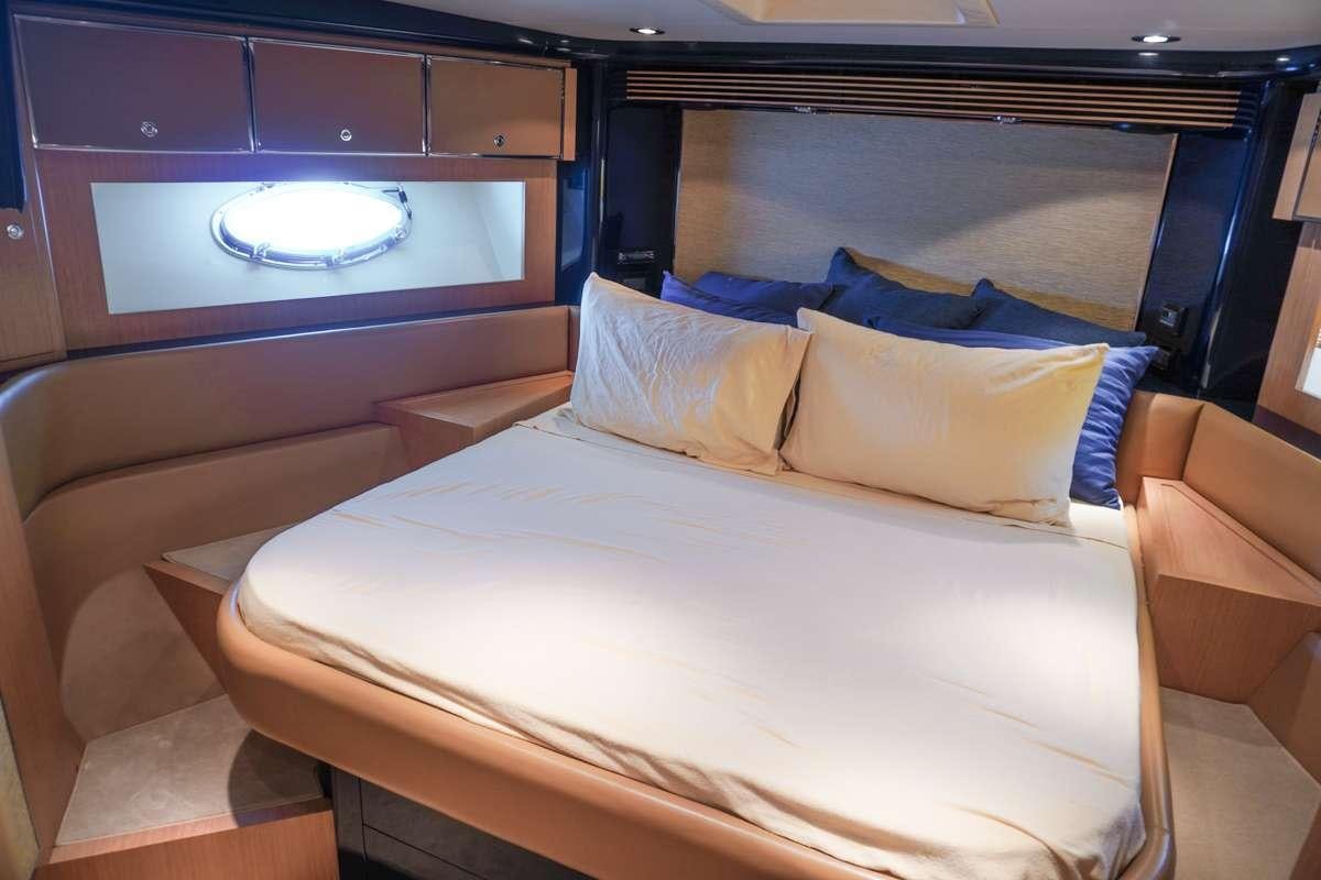a bed with pillows aboard EXPRESSO Yacht for Charter