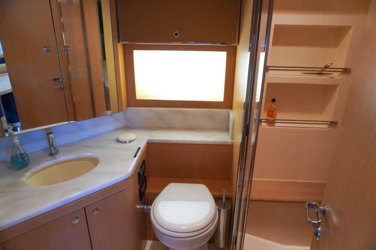 a bathroom with a toilet and a sink aboard EXPRESSO Yacht for Charter