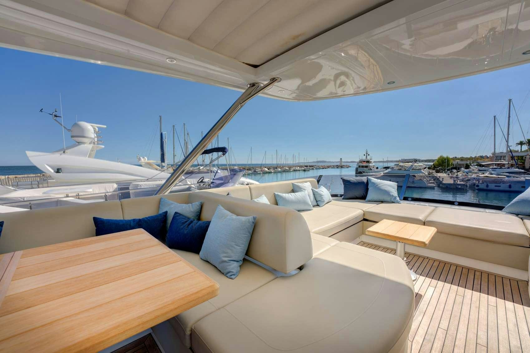 a large lounge area with a large ship in the background aboard MIKEL ANGELO Yacht for Charter