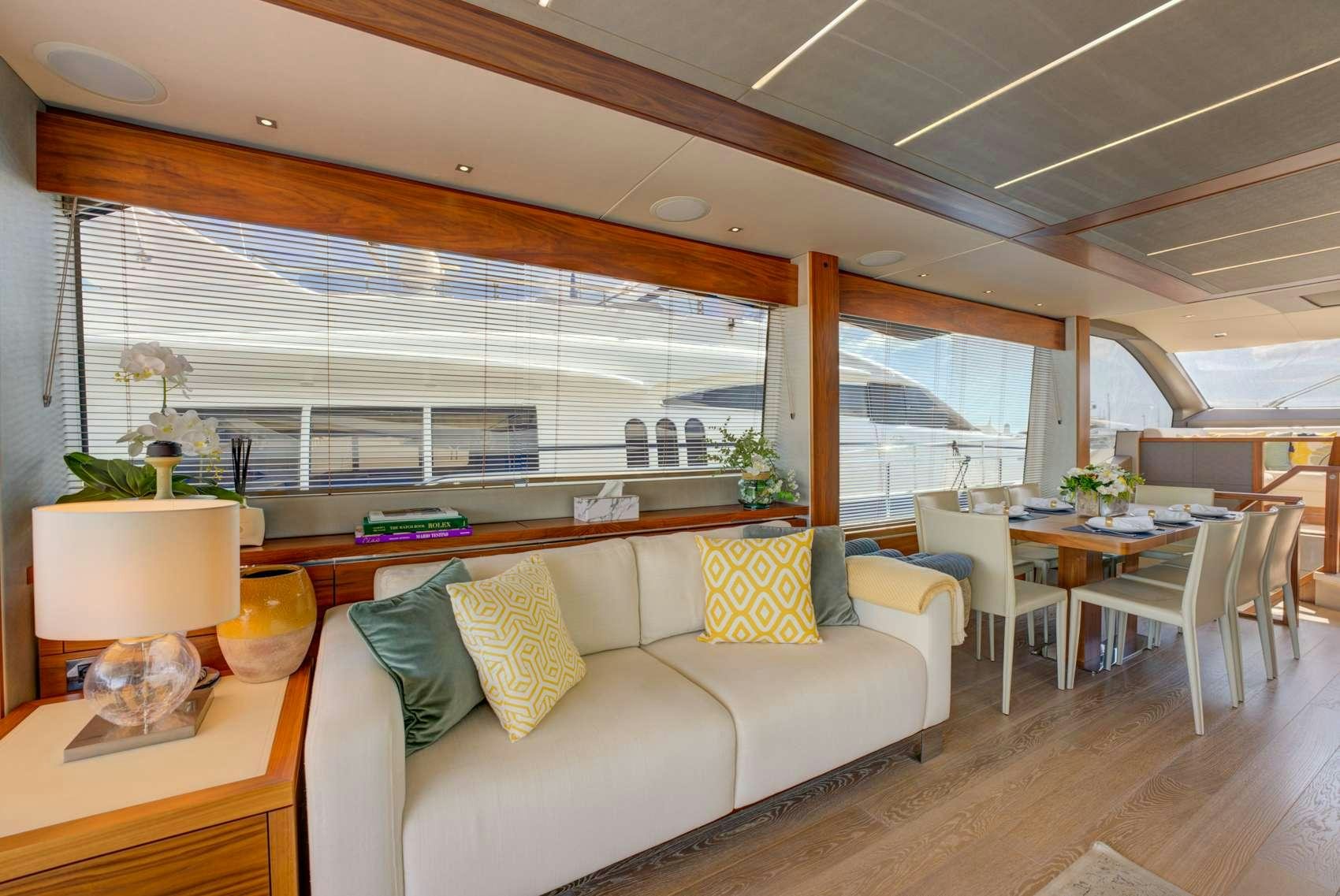 a living room with a couch and a table aboard MIKEL ANGELO Yacht for Charter