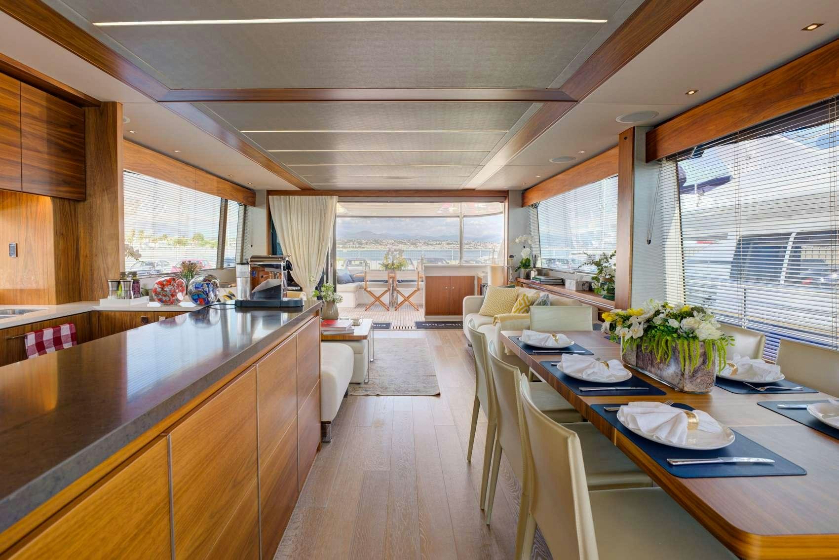 a large kitchen with a dining table aboard MIKEL ANGELO Yacht for Charter