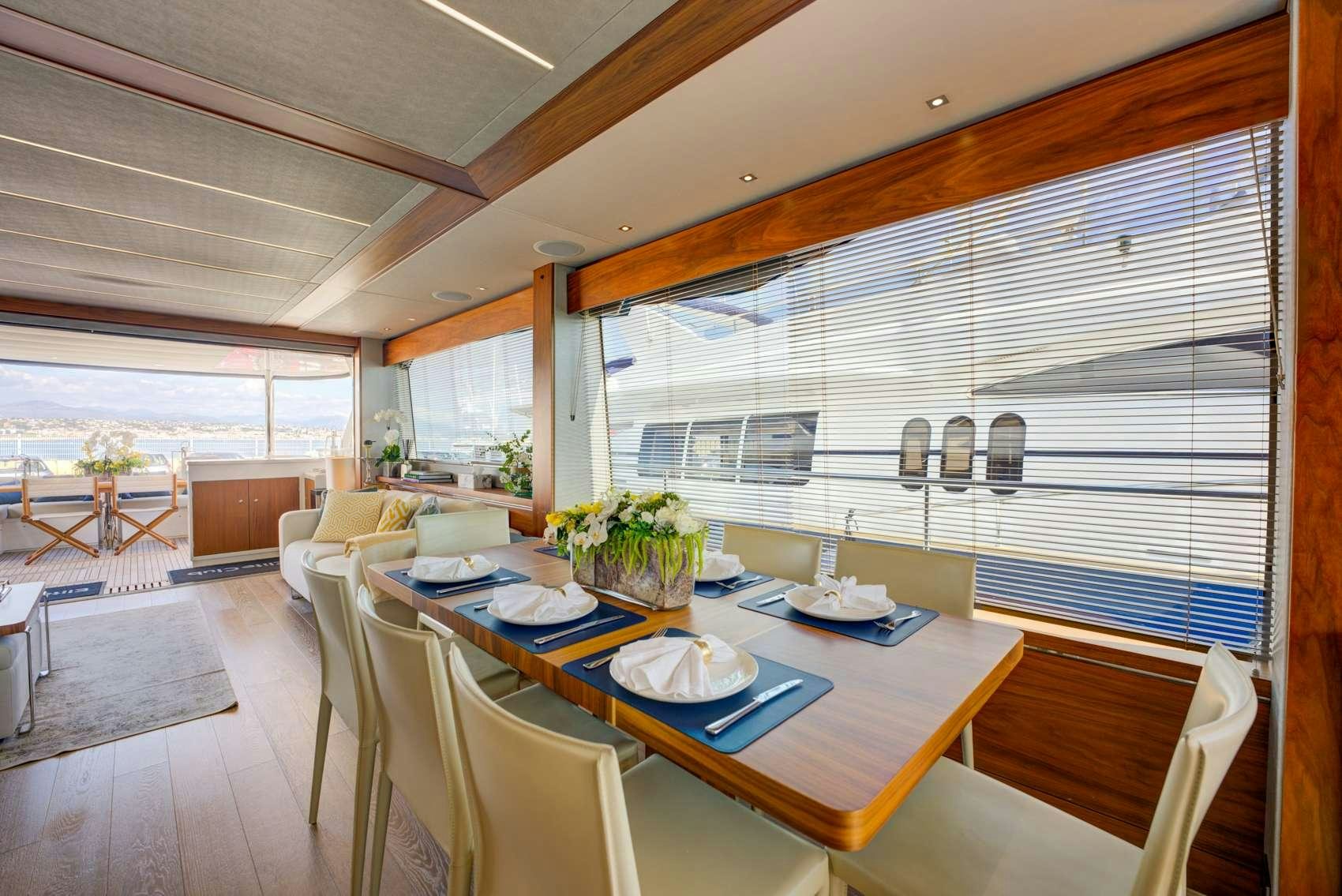a large dining room with a large window aboard MIKEL ANGELO Yacht for Charter