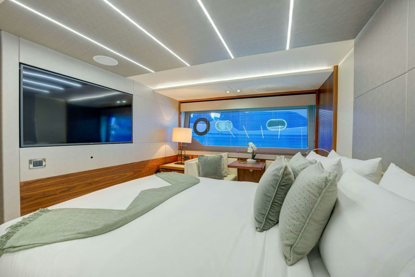 a room with a bed and a television aboard MIKEL ANGELO Yacht for Charter
