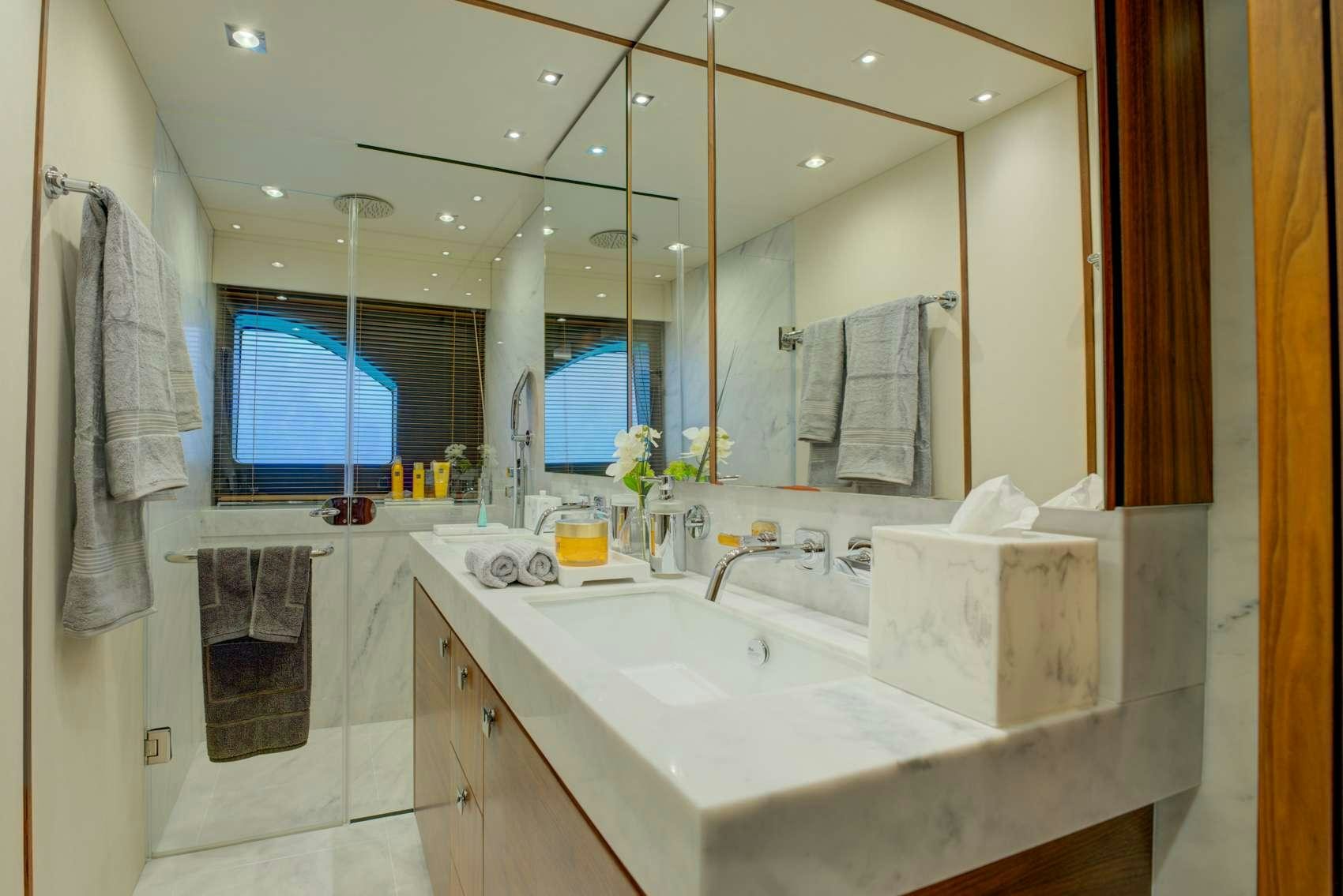 a bathroom with a sink and towels aboard MIKEL ANGELO Yacht for Charter