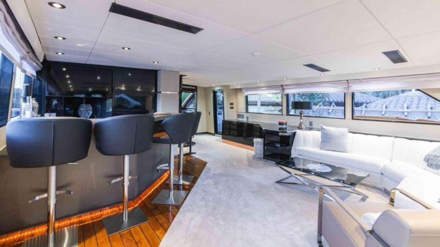 a room with chairs and tables aboard QUANTUM Yacht for Charter