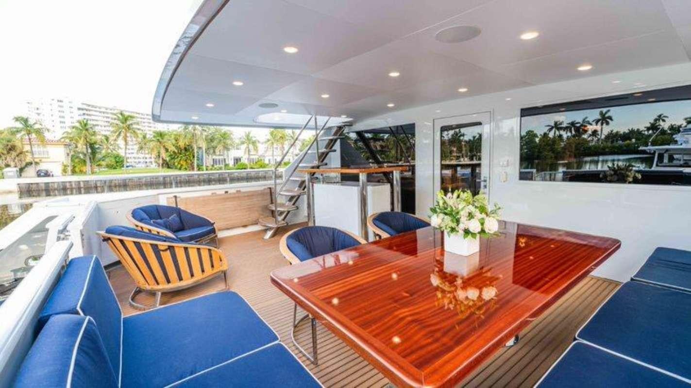 a large room with a table and chairs aboard QUANTUM Yacht for Charter