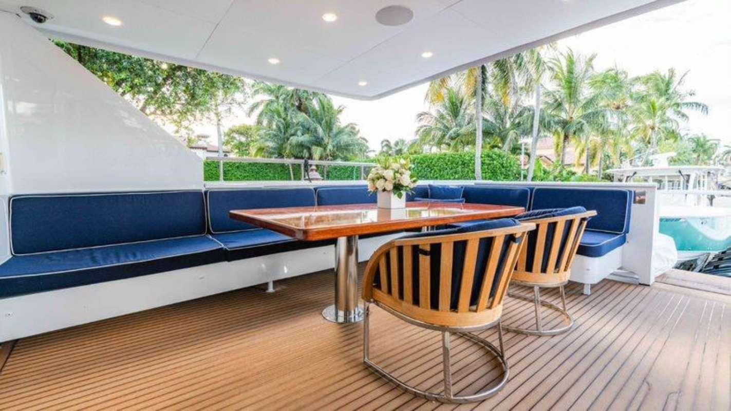 a room with a table and chairs aboard QUANTUM Yacht for Charter