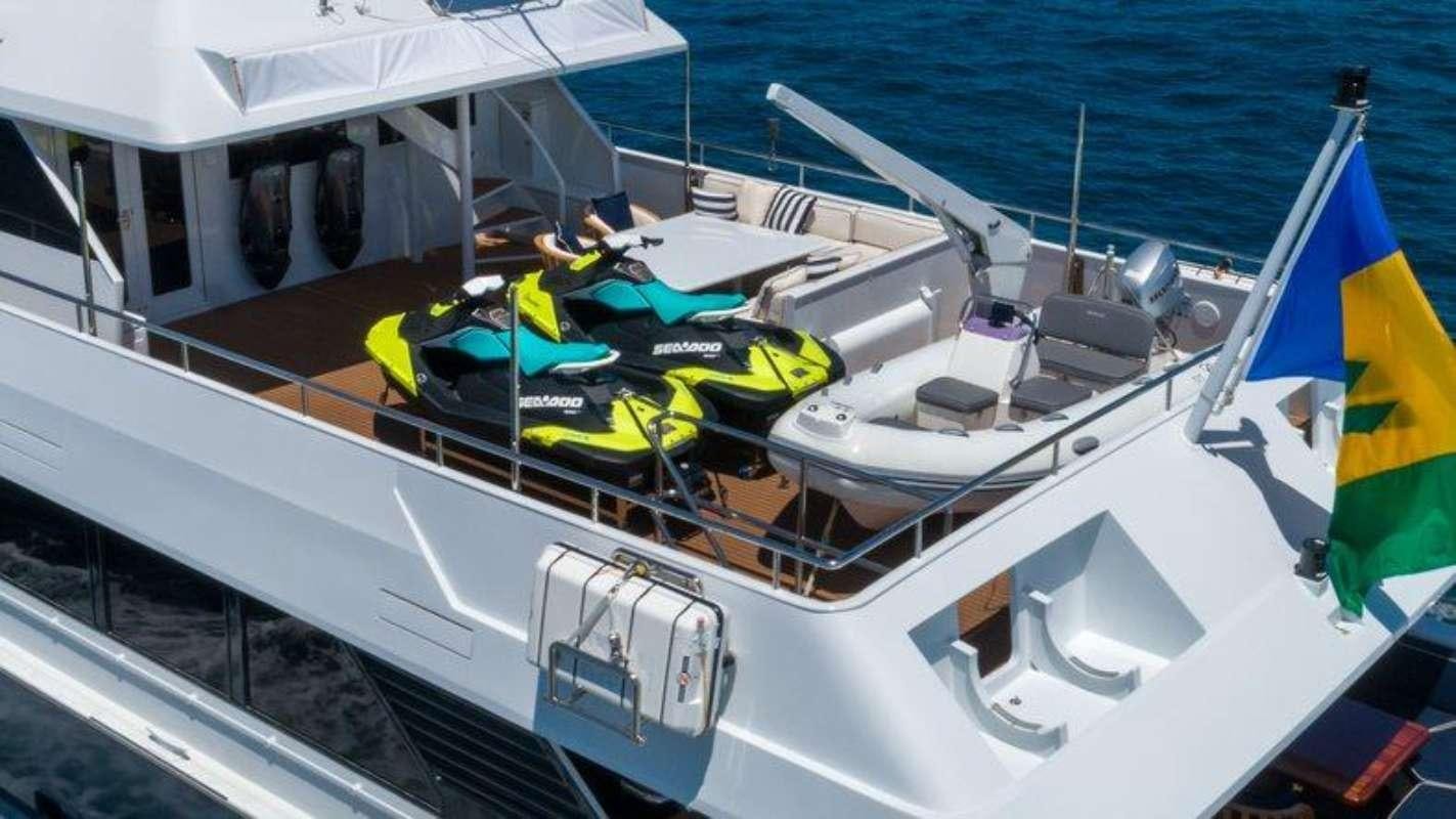 a boat with a flag on the deck aboard QUANTUM Yacht for Charter