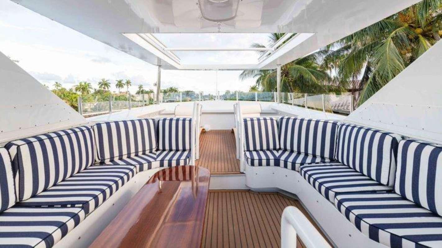 a deck with white chairs and a large white awning aboard QUANTUM Yacht for Charter
