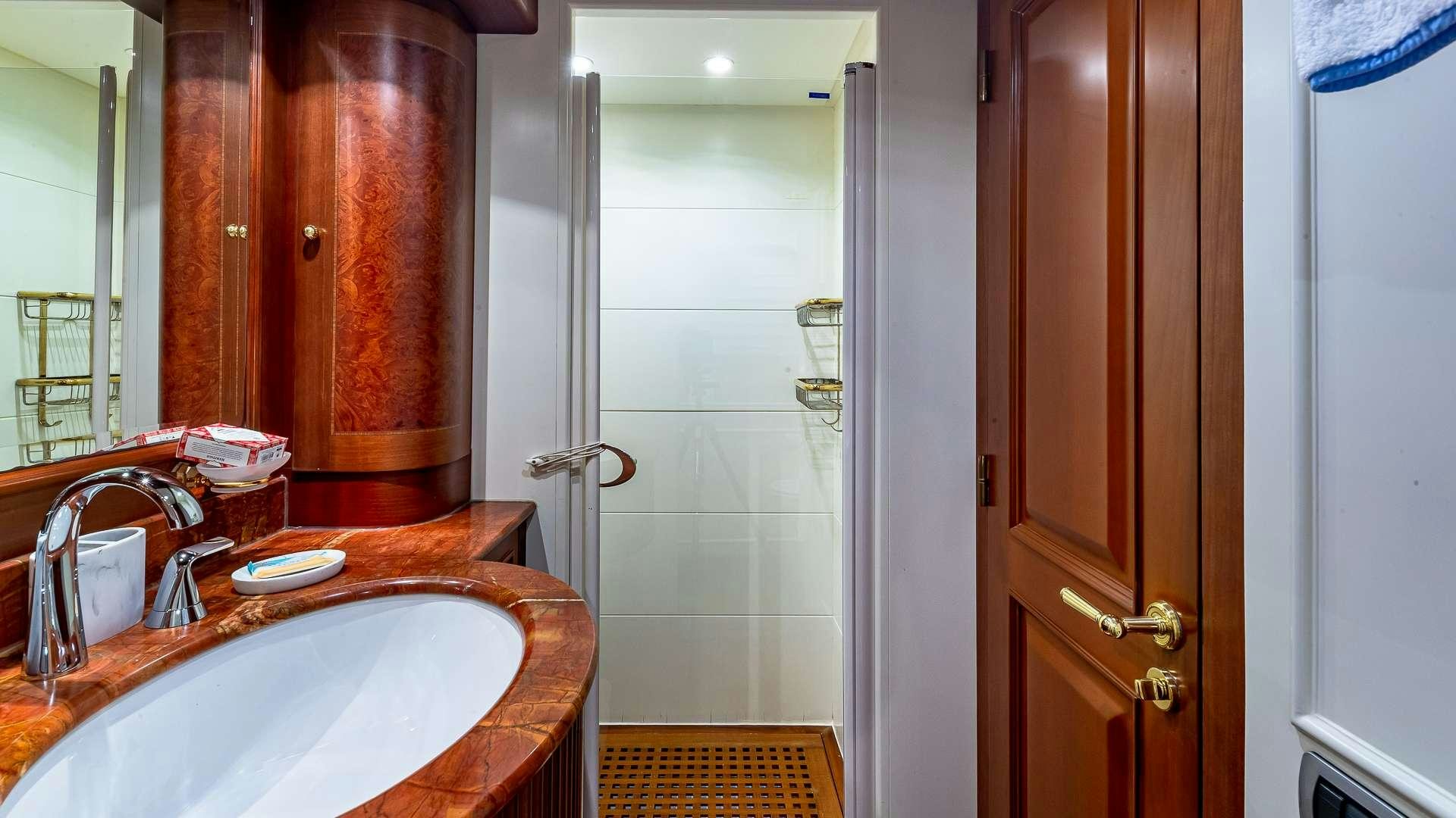 a bathroom with a sink and a door aboard POUR ANOTHER Yacht for Charter