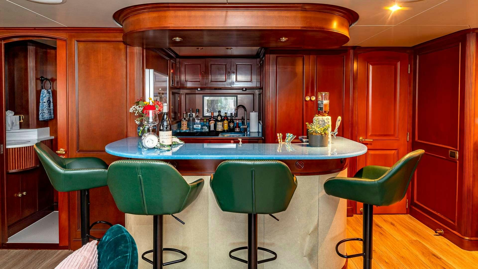 a table with chairs around it aboard POUR ANOTHER Yacht for Charter