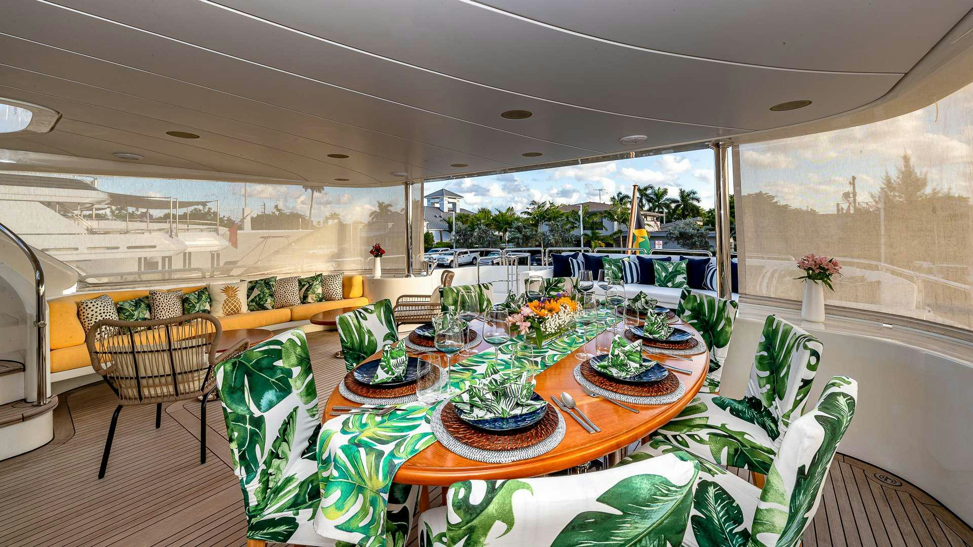 a room with tables and chairs aboard POUR ANOTHER Yacht for Charter