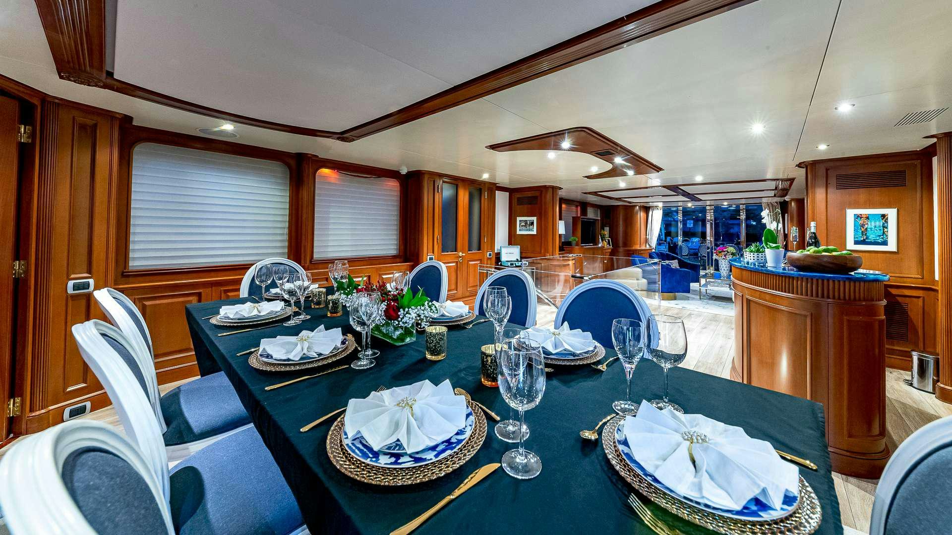 a dining room with a table set aboard POUR ANOTHER Yacht for Charter