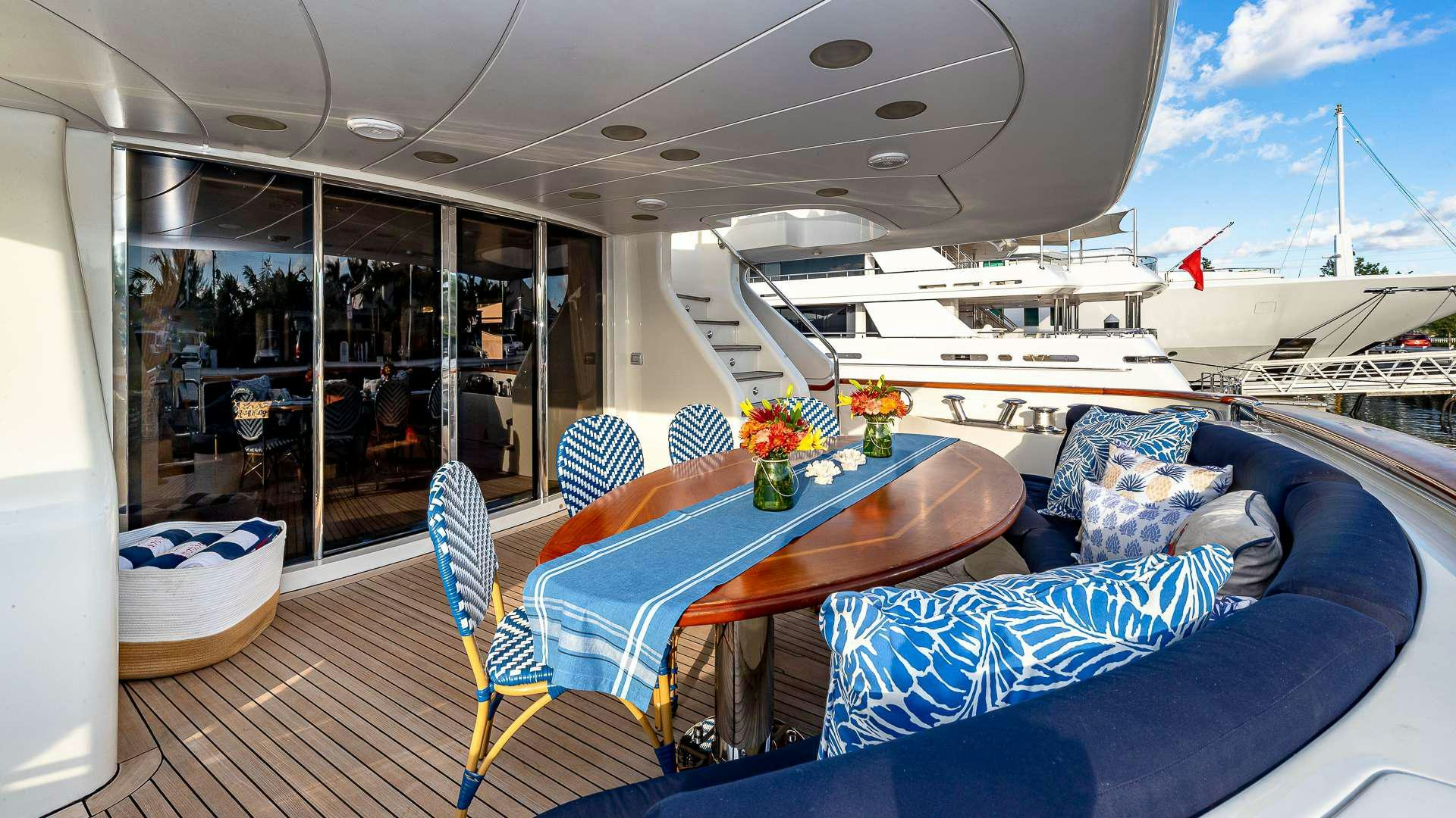 a boat with a table and chairs aboard POUR ANOTHER Yacht for Charter