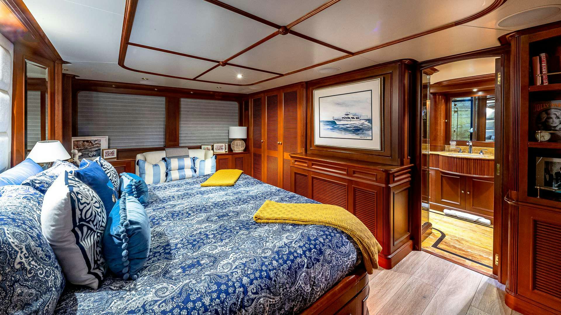 a bedroom with a bed and a closet aboard POUR ANOTHER Yacht for Charter