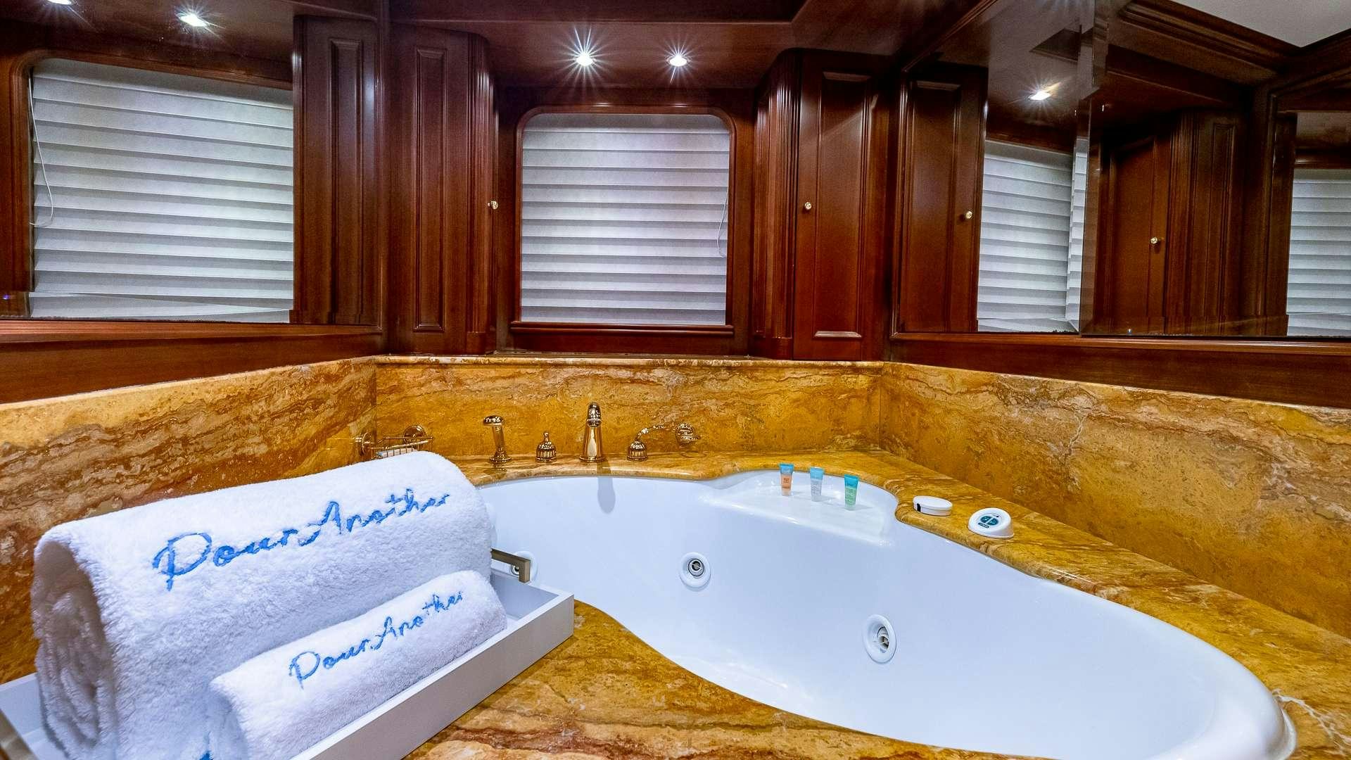 a bathroom with a tub and a sink aboard POUR ANOTHER Yacht for Charter