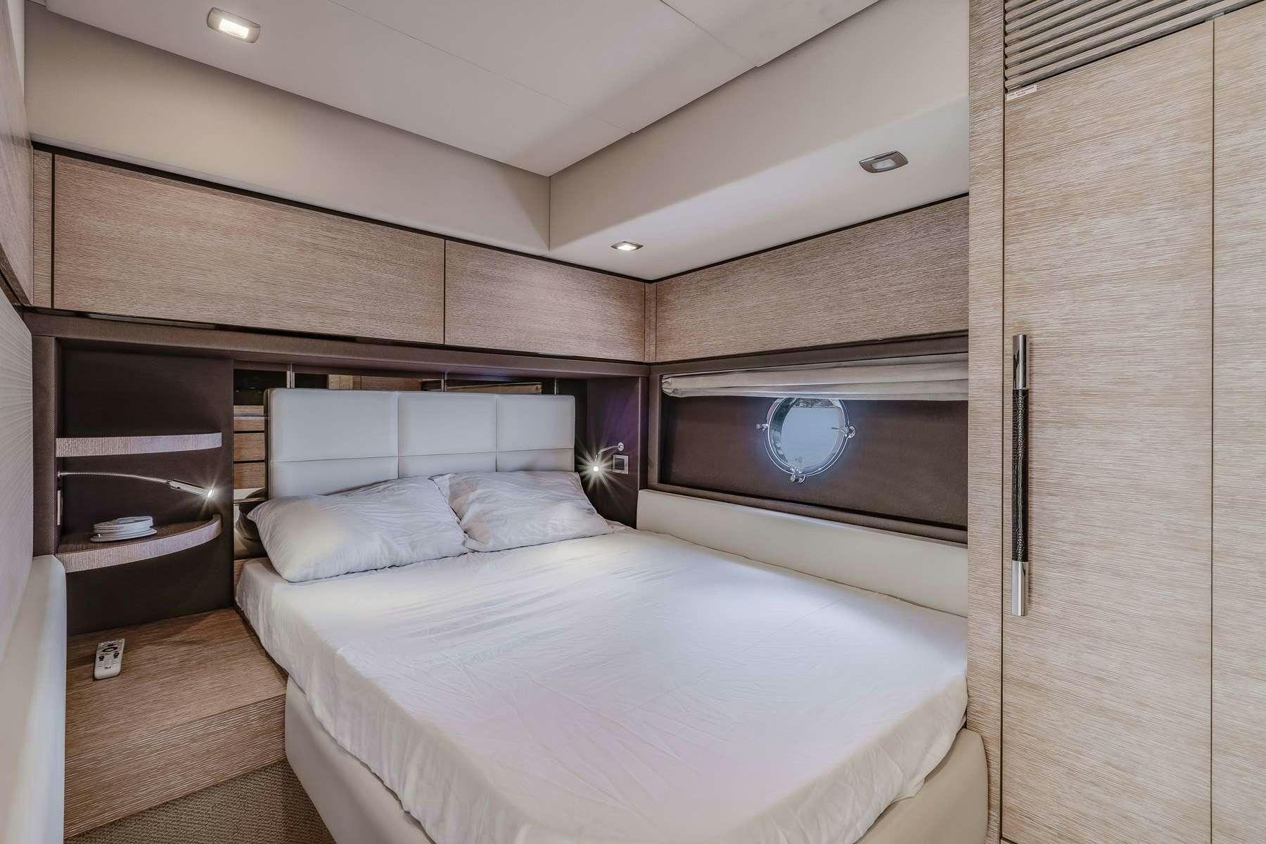a room with a bed and a television aboard DAYS LIKE THIS Yacht for Charter