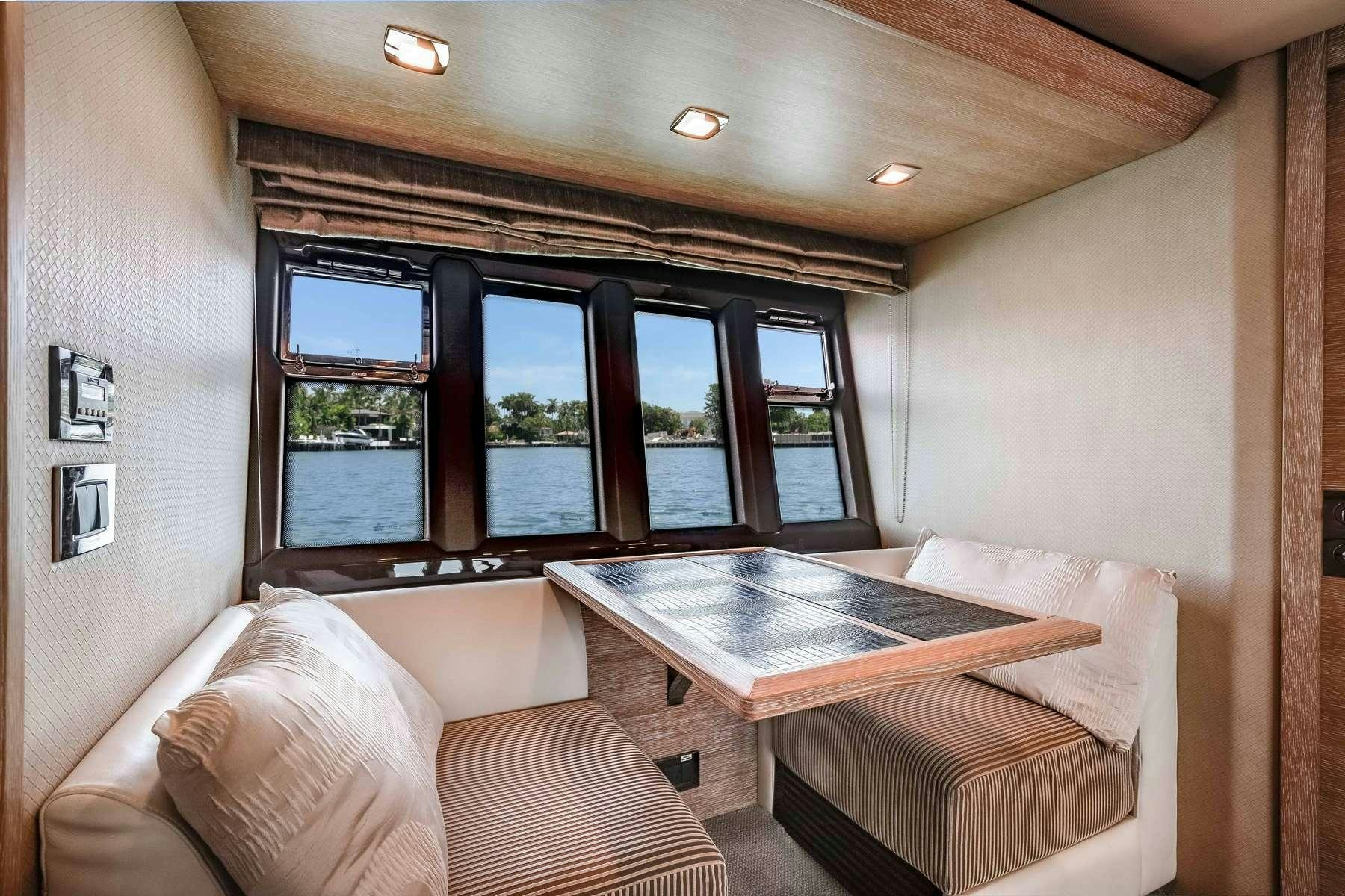 a living room with a table and couches aboard DAYS LIKE THIS Yacht for Charter