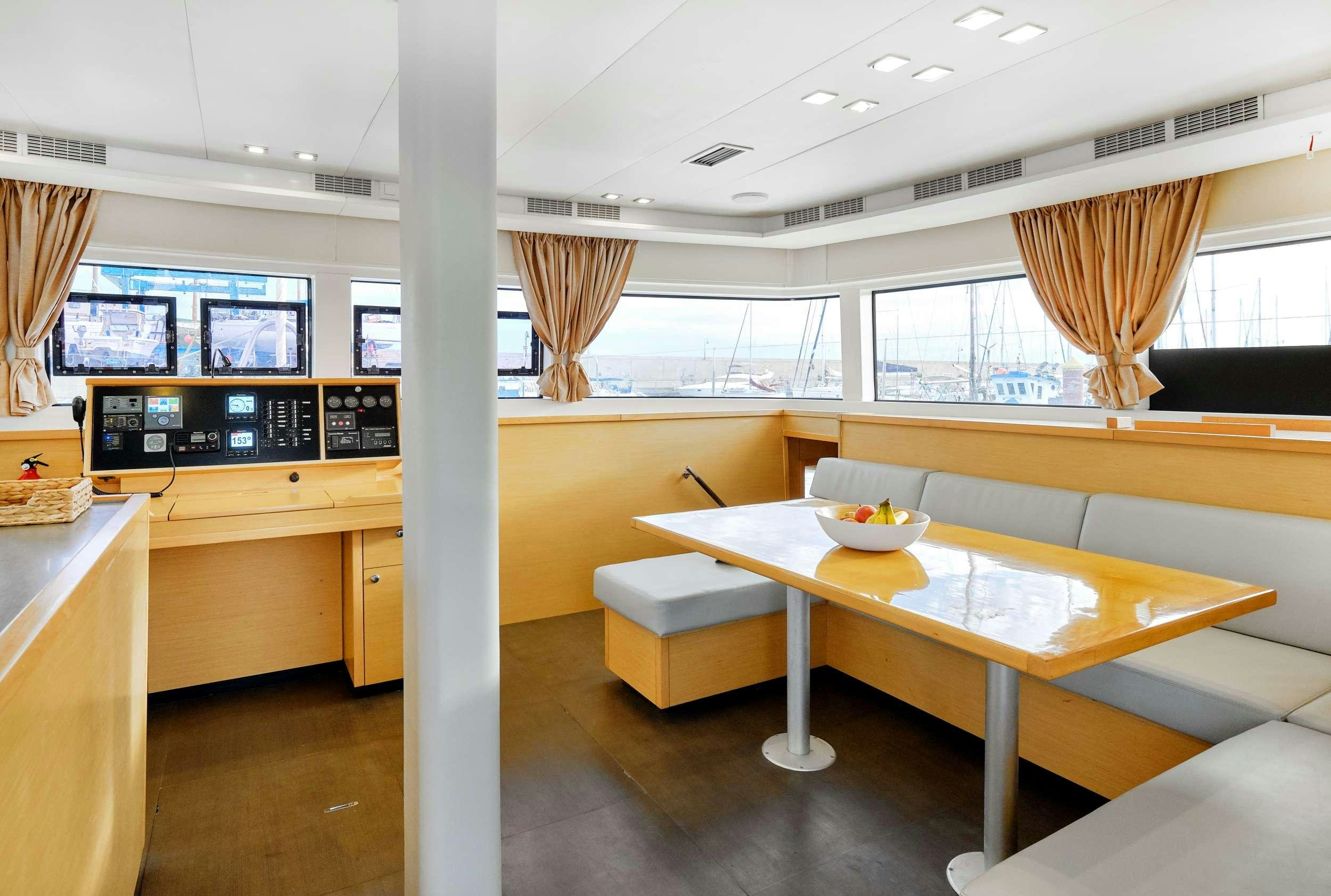 a room with a table and chairs aboard Neptuno Yacht for Charter