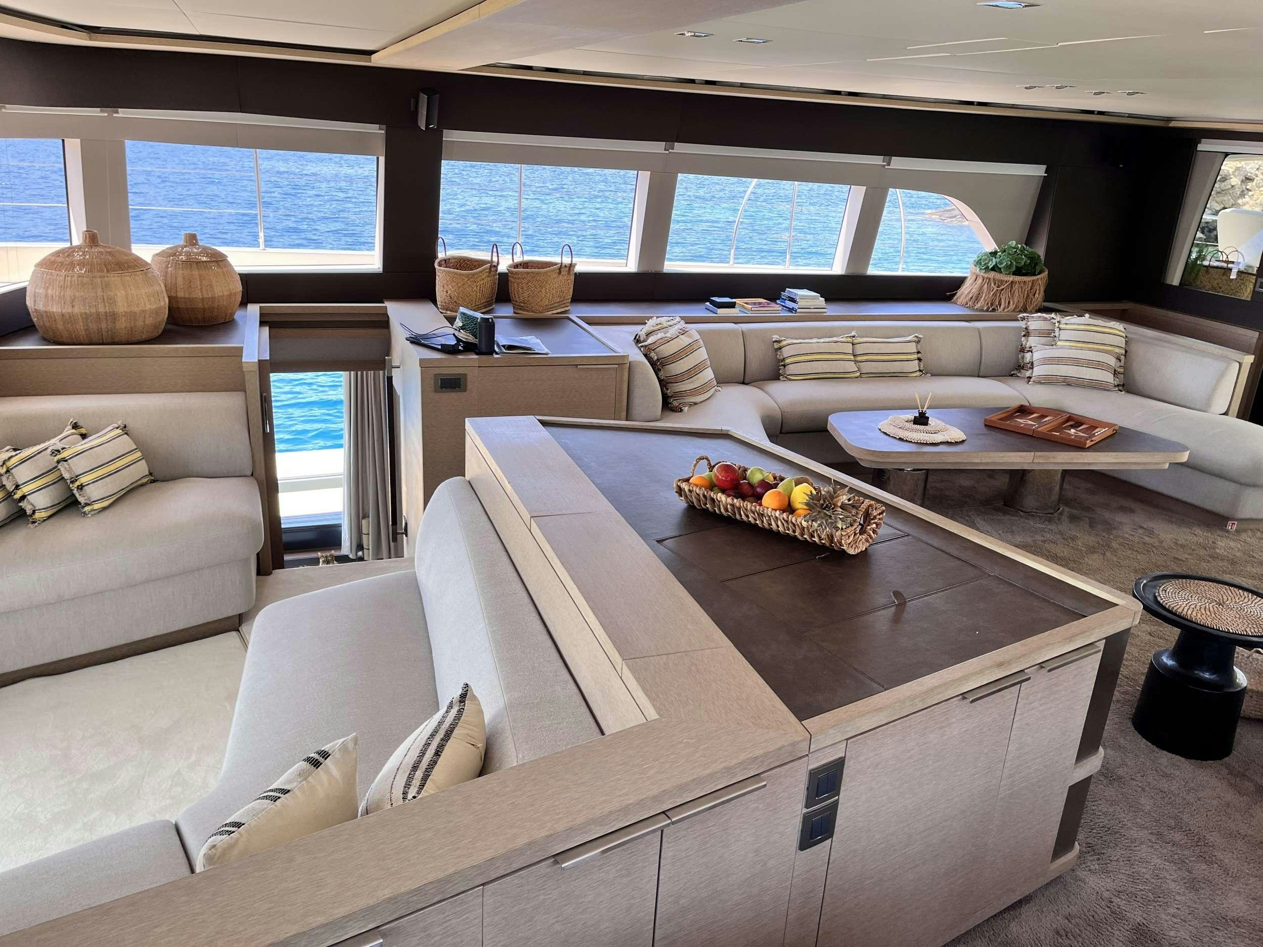 a living room with a large table aboard JUST MARIE 2 Yacht for Charter