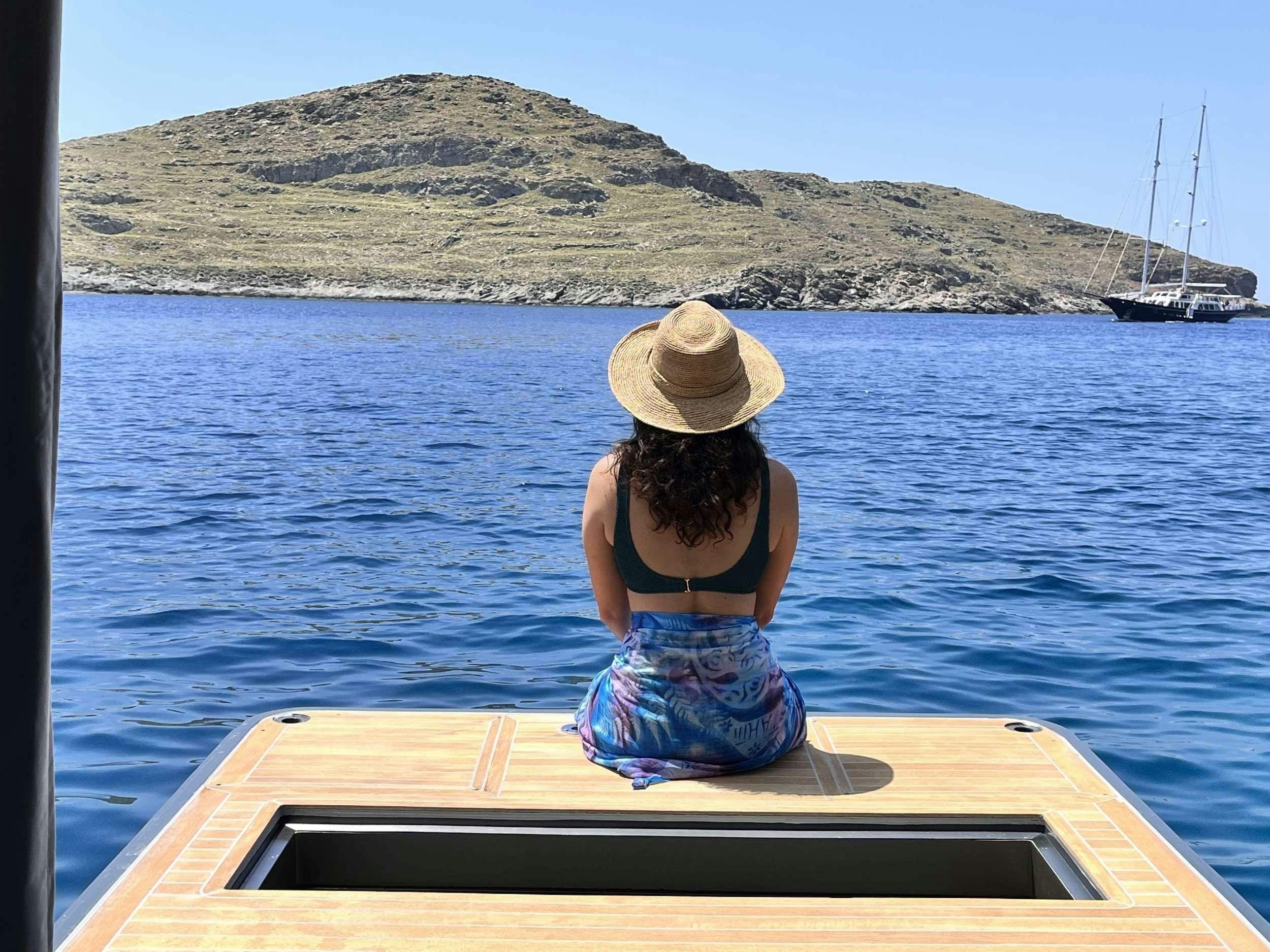 a person sitting on a dock aboard JUST MARIE 2 Yacht for Charter