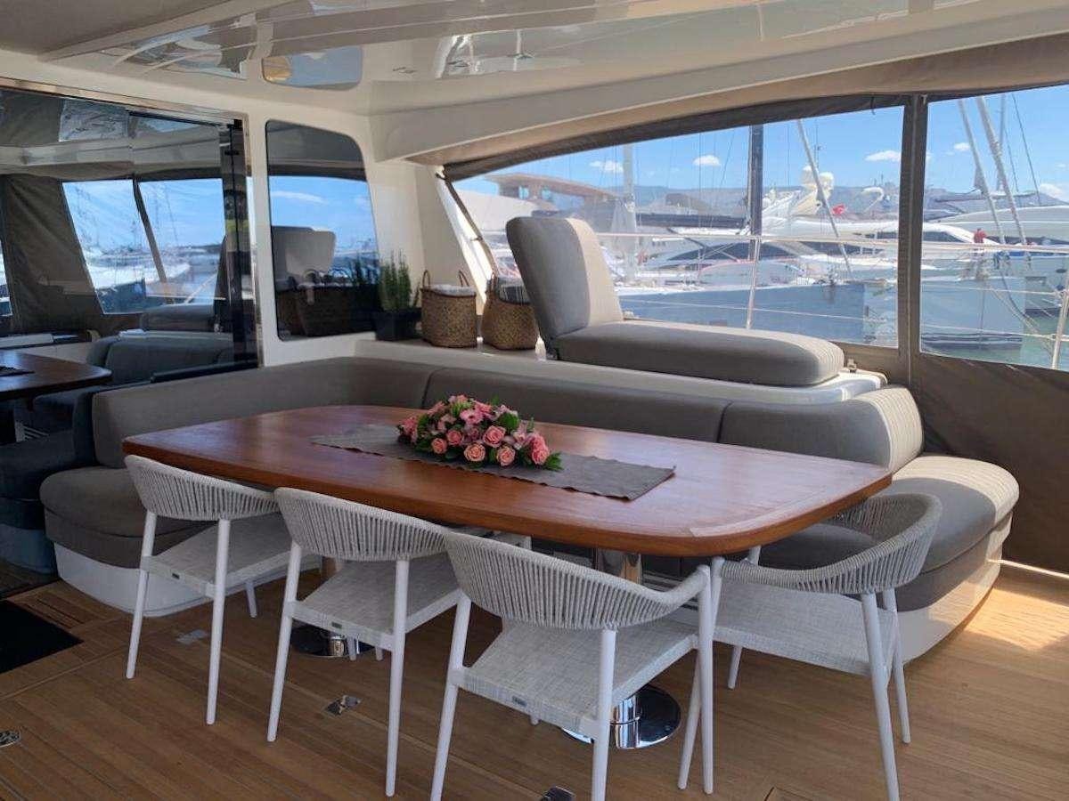 a table with chairs around it aboard JUST MARIE 2 Yacht for Charter
