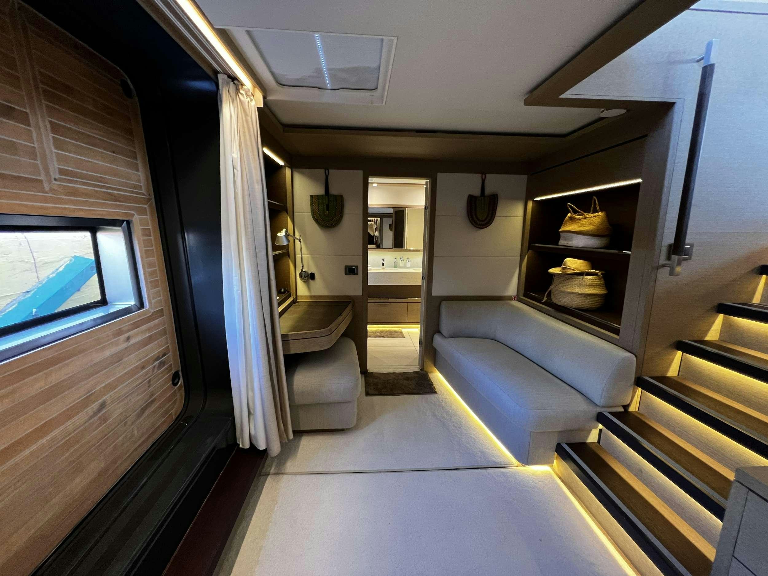a room with a couch and a window aboard JUST MARIE 2 Yacht for Charter