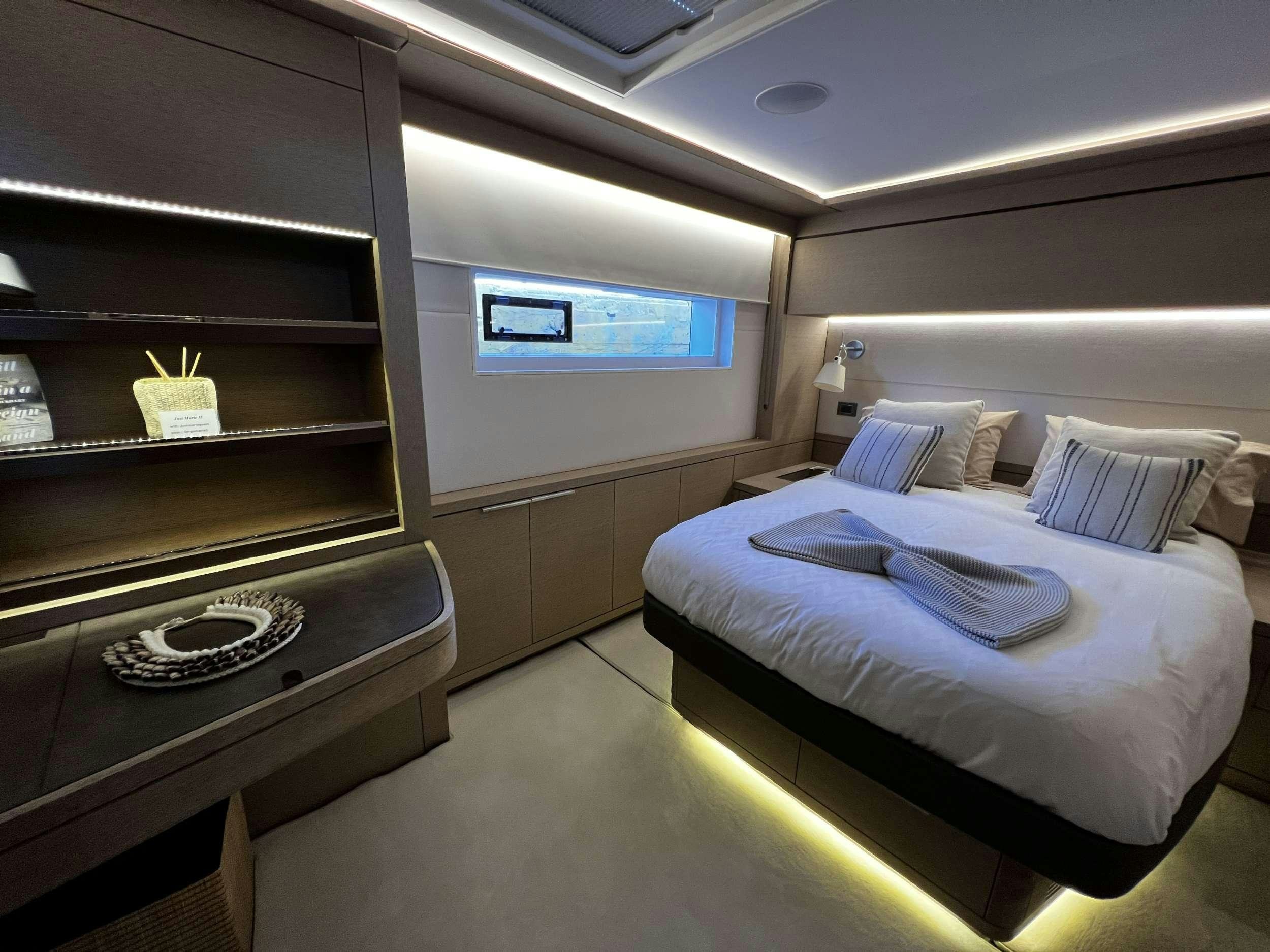 a room with a bed and a shelf aboard JUST MARIE 2 Yacht for Charter