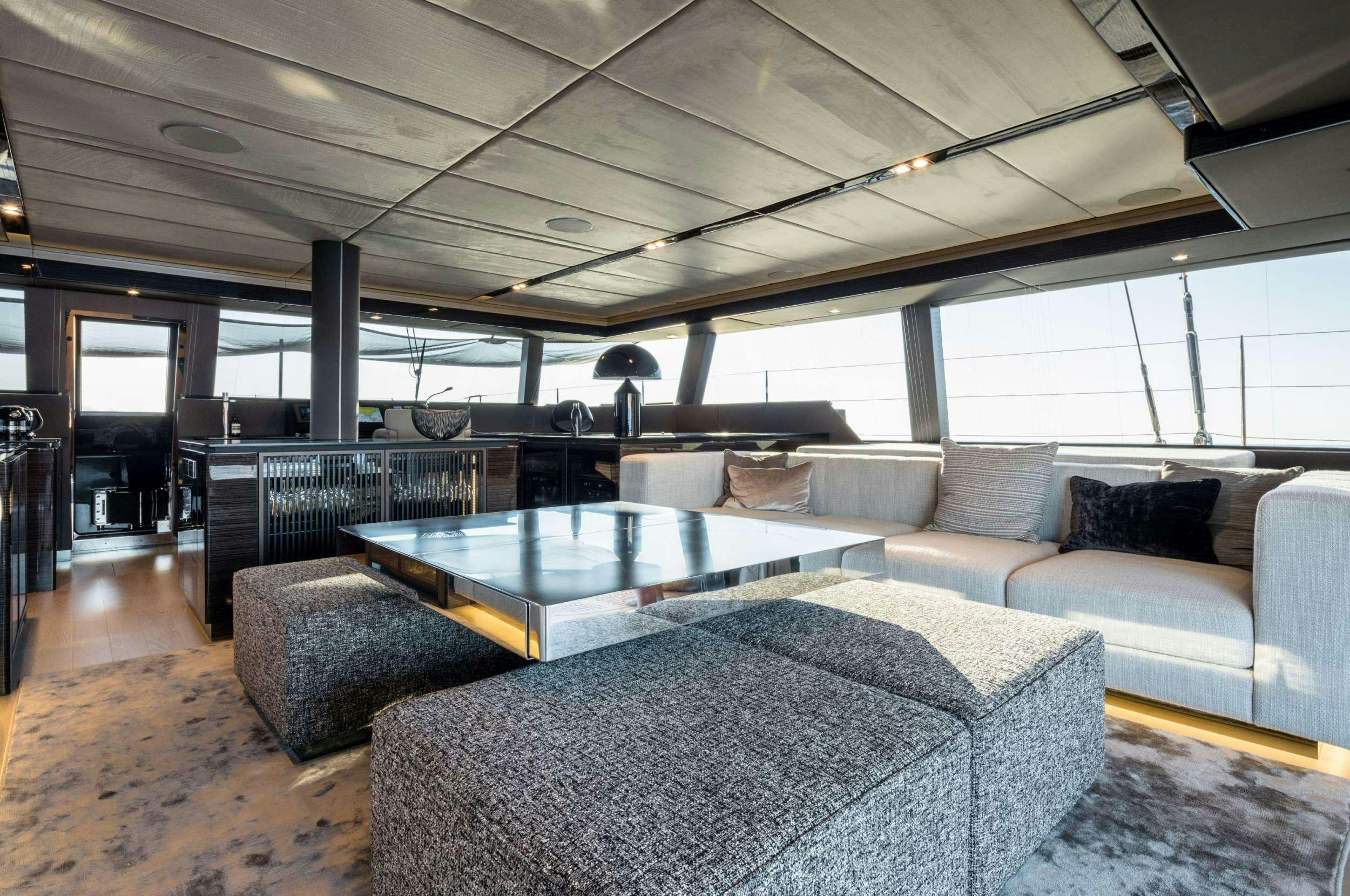 a large room with a table and chairs aboard ANIMA Yacht for Charter