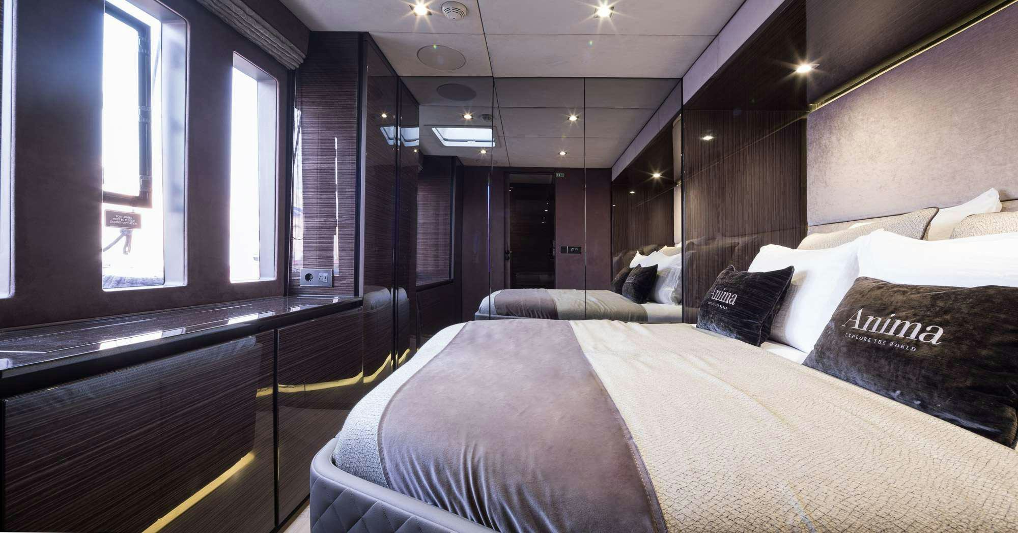 a room with a bed and a window aboard ANIMA Yacht for Charter